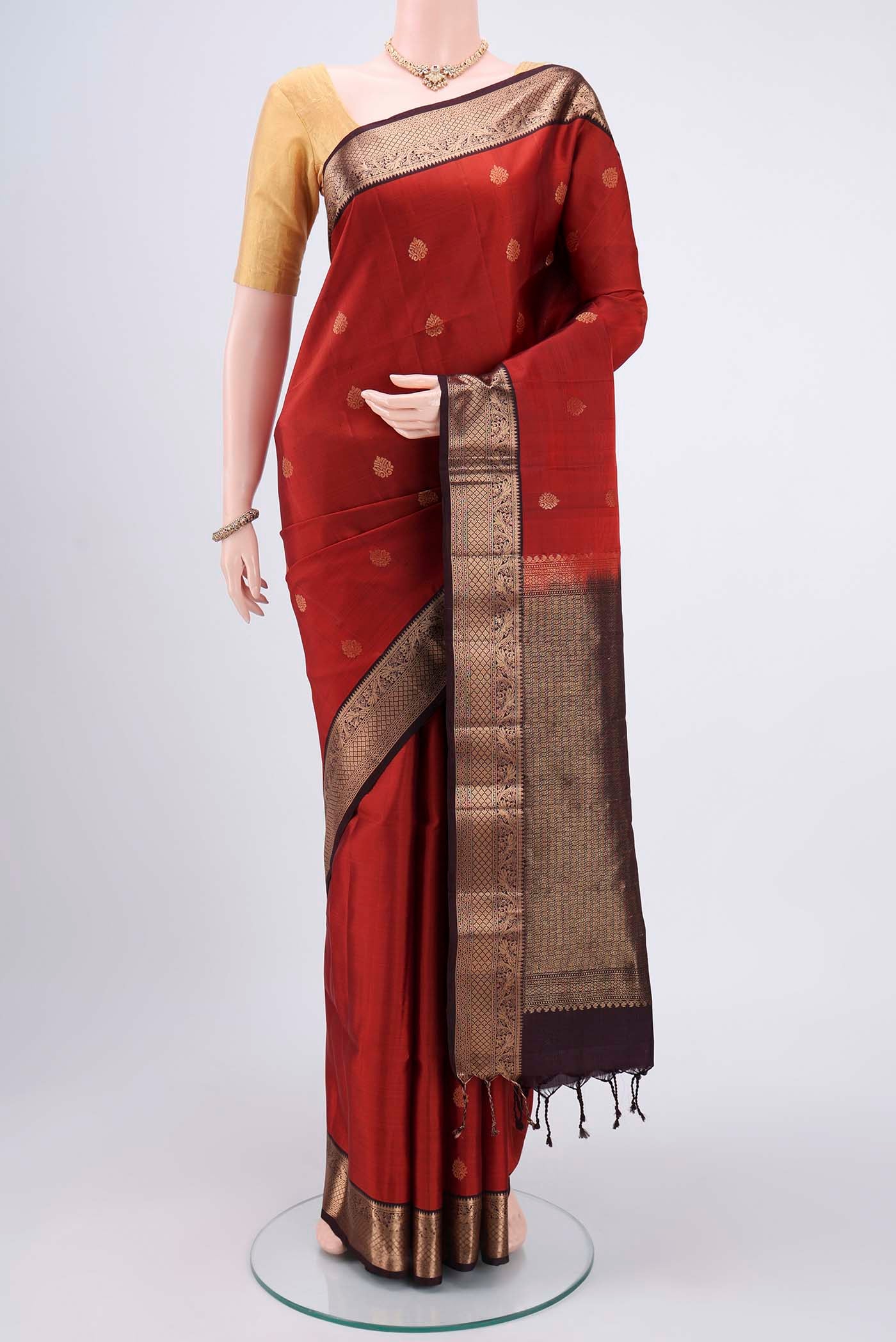 Brick Orange Bangalore Silk Saree with Zari Butta on the body and Zari Border.  displayed on a mannequin