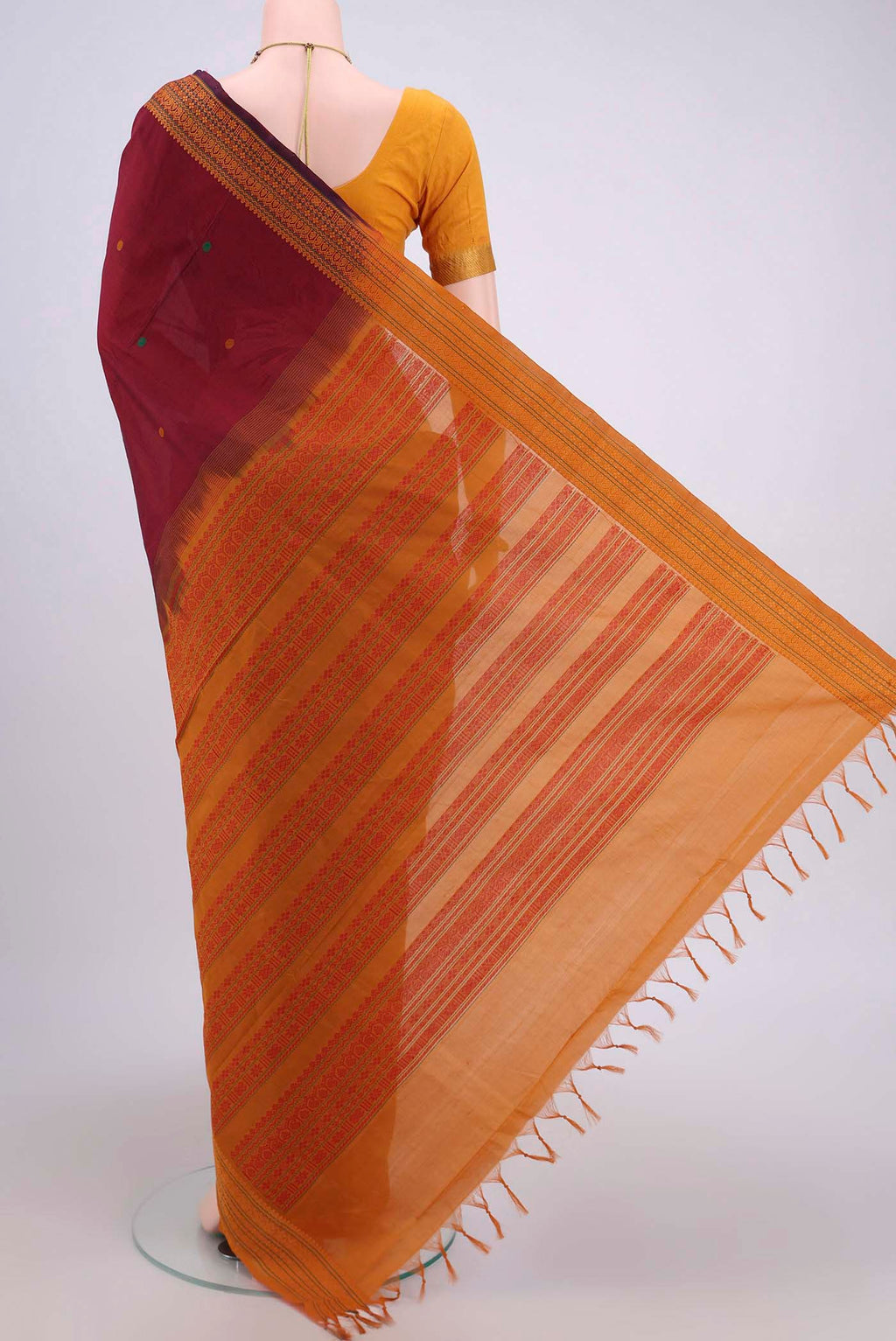 Flat view of Maroon Blended Poly Cotton Saree with Thread Butta on the body and Thread Border. 