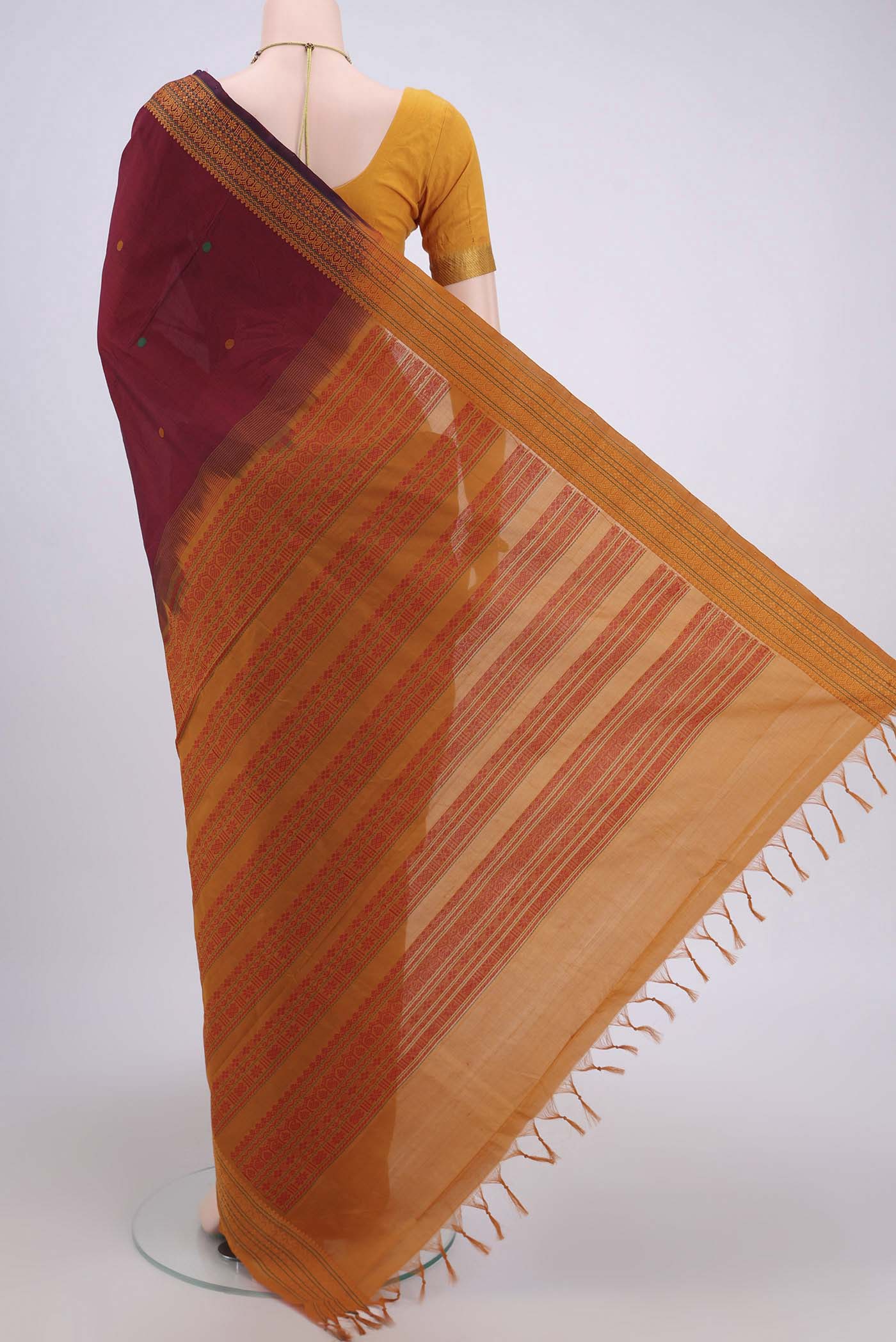 Flat view of Maroon Blended Poly Cotton Saree with Thread Butta on the body and Thread Border. 