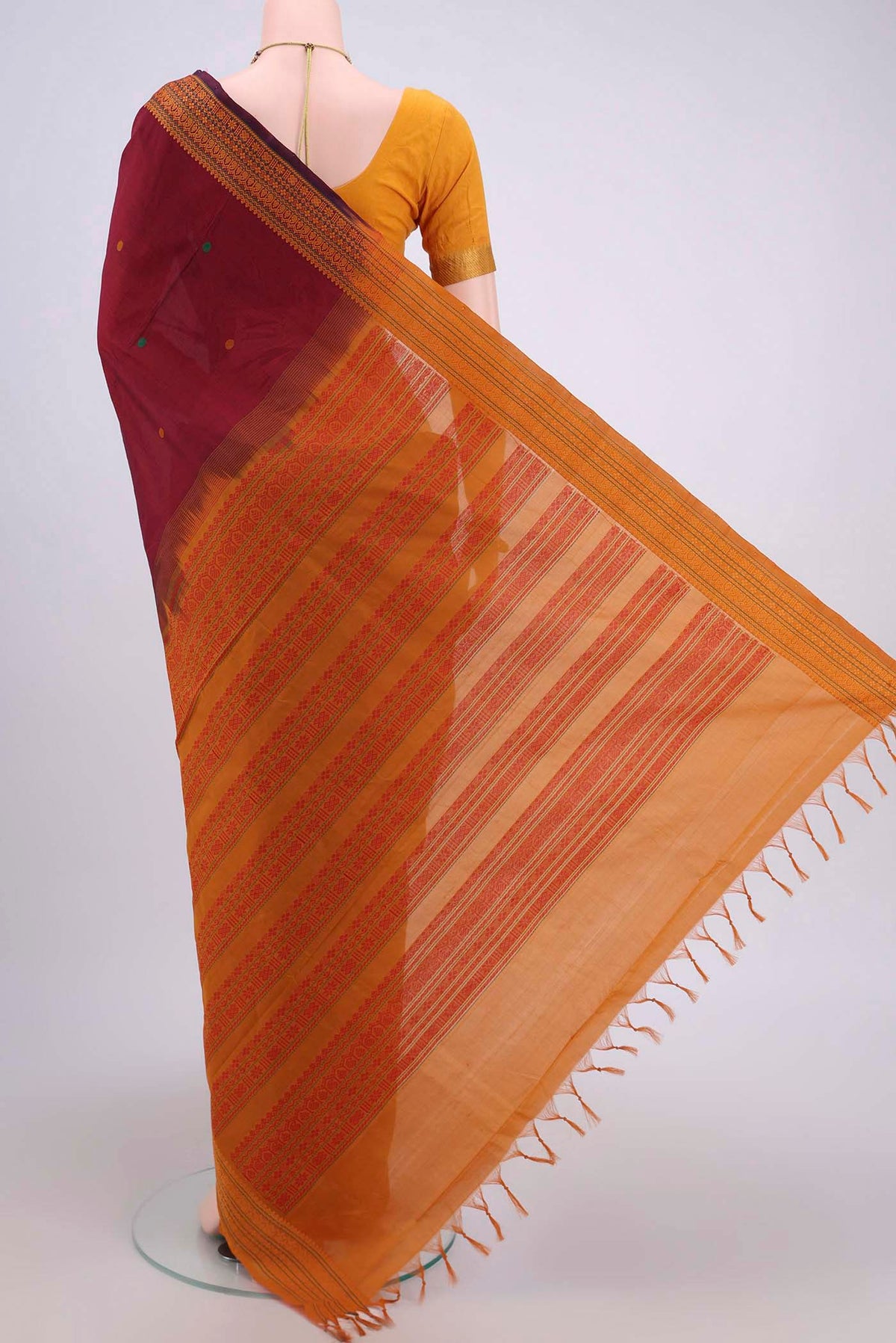 Flat view of Maroon Blended Poly Cotton Saree with Thread Butta on the body and Thread Border. 