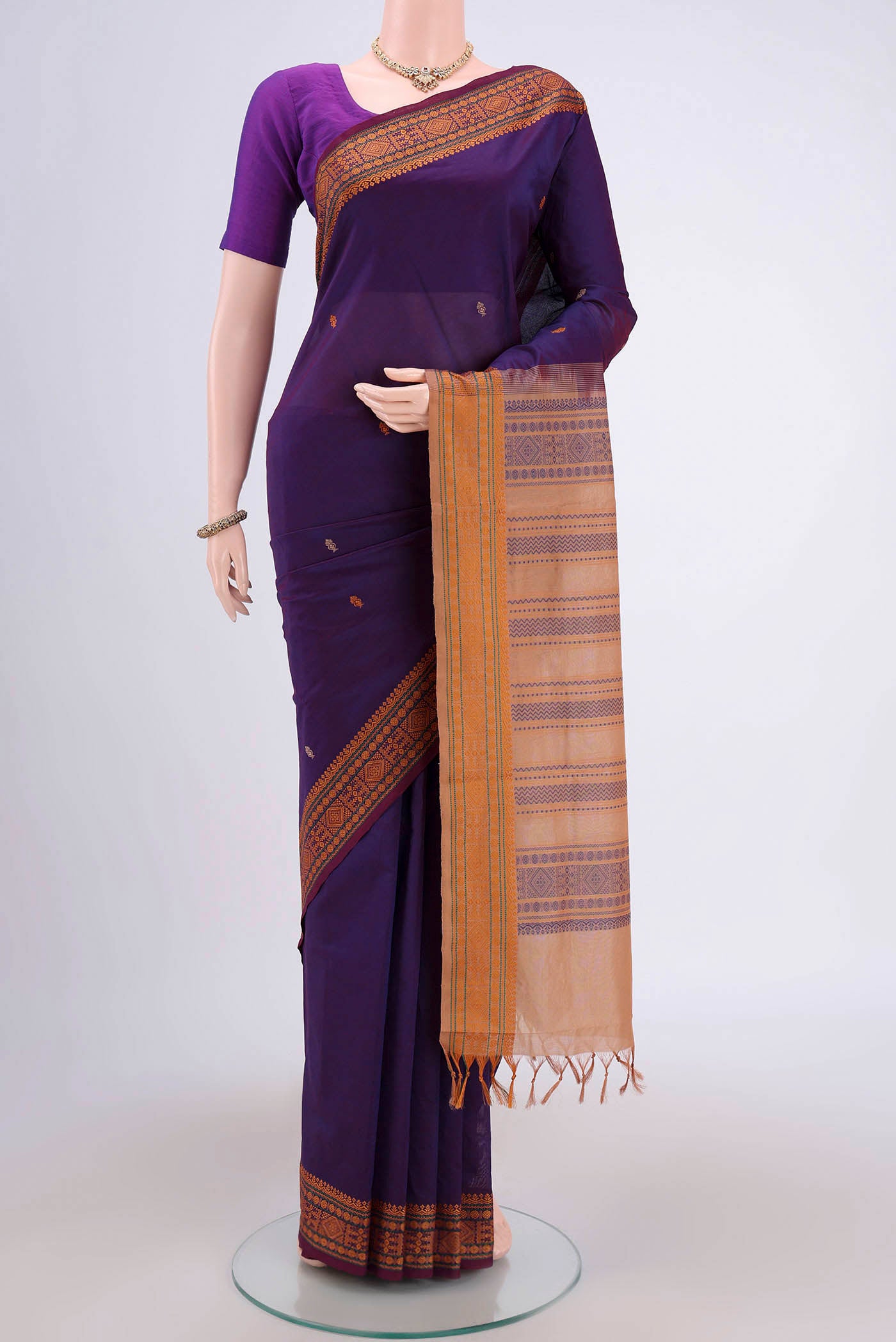 Purple Blended Poly Cotton Saree with Thread Butta on the body and Thread Border.  displayed on a mannequin