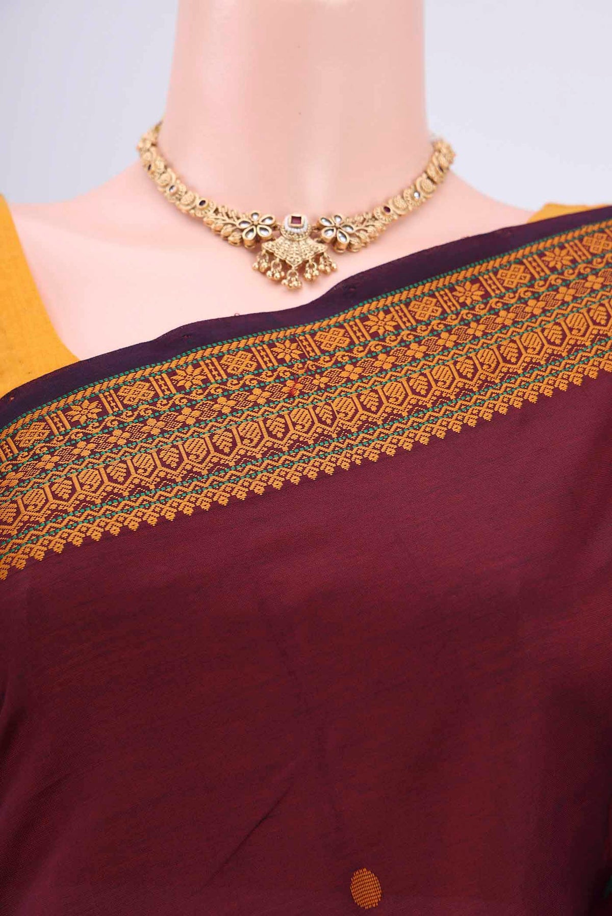 Border image of Maroon Blended Poly Cotton Saree with Thread Butta on the body and Thread Border. 
