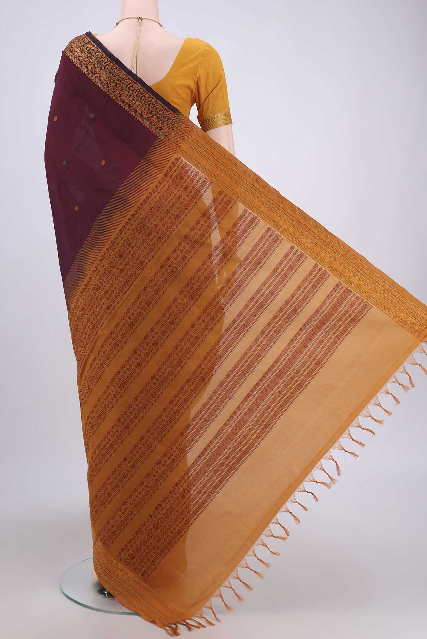 Flat view of Maroon Blended Poly Cotton Saree with Thread Butta on the body and Thread Border. 