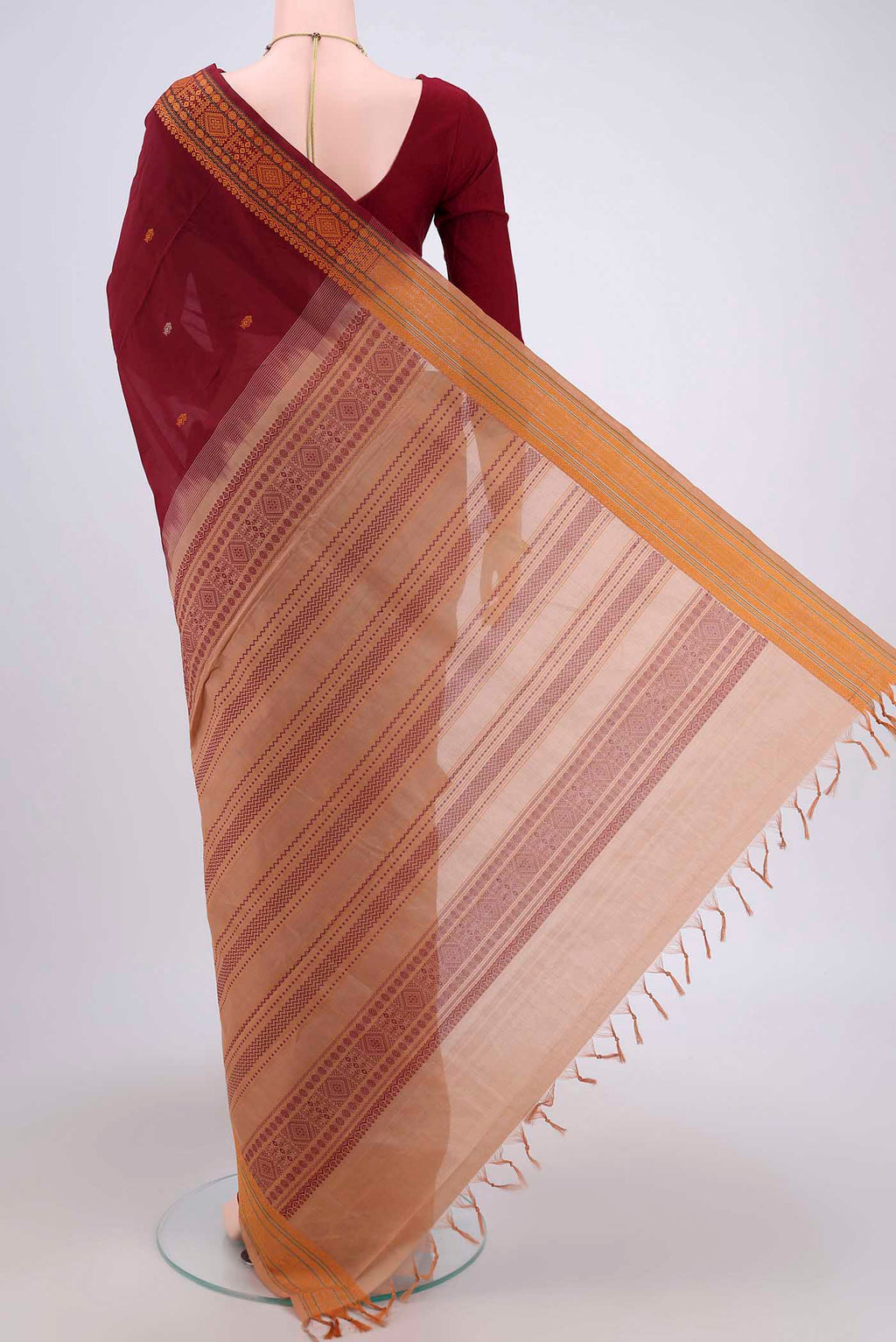 Flat view of Maroon Blended Poly Cotton Saree with Thread Butta on the body and Thread Border. 