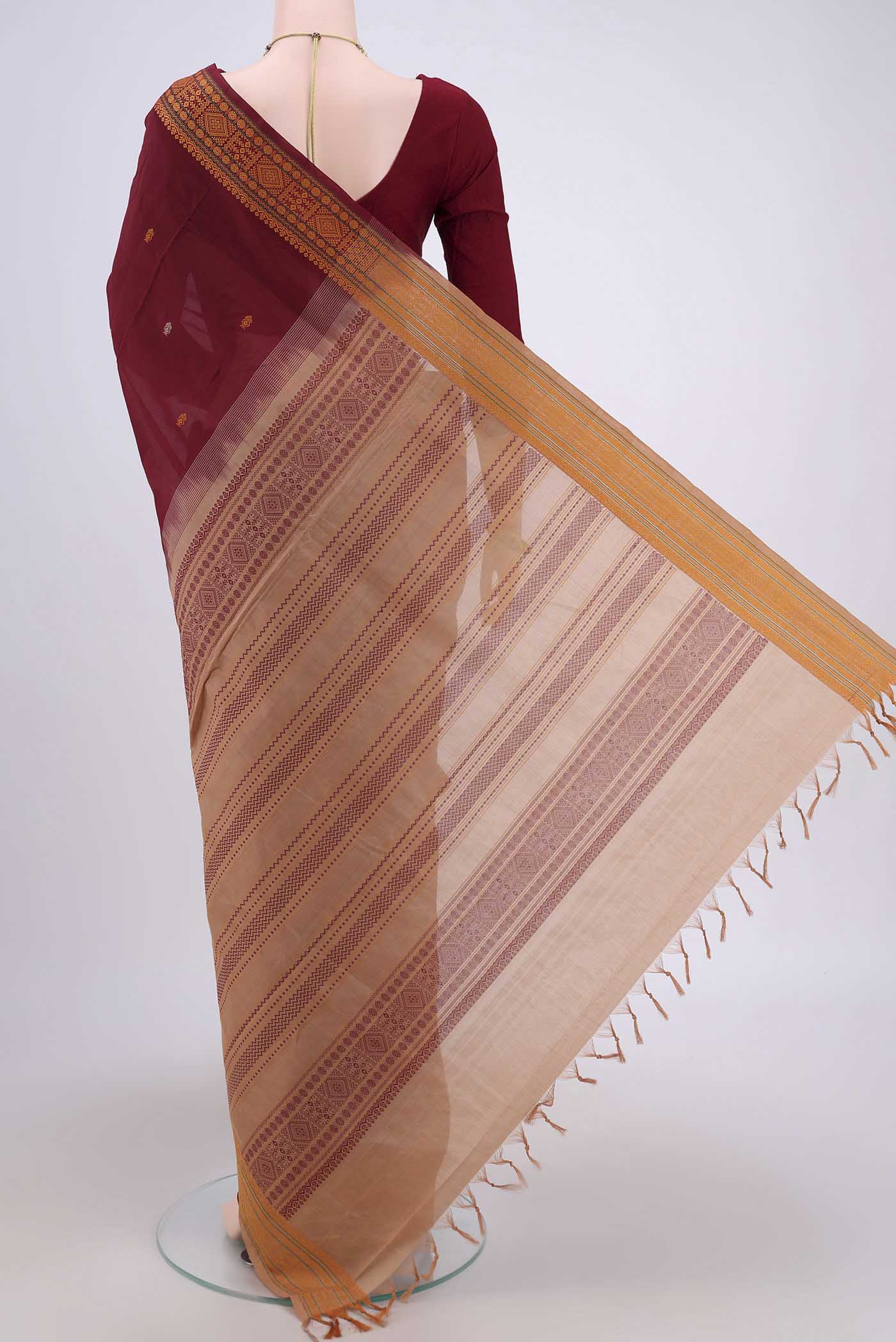 Flat view of Maroon Blended Poly Cotton Saree with Thread Butta on the body and Thread Border. 