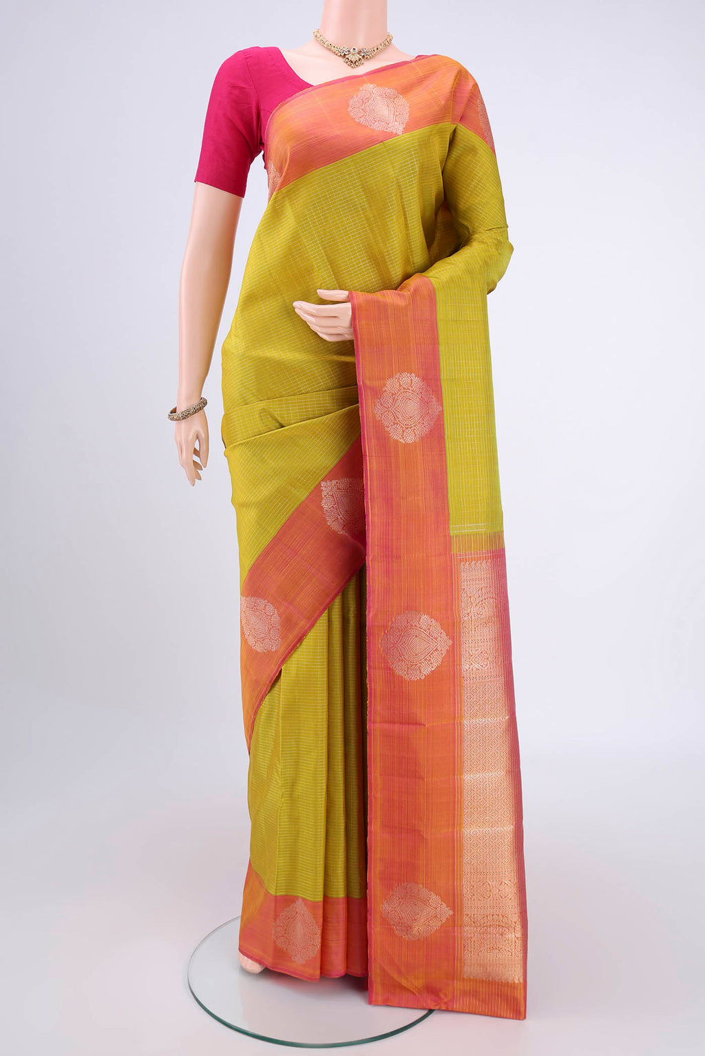 Acid Green Kanjivaram Silk Saree with Checked design on the body and Zari Border.  displayed on a mannequin