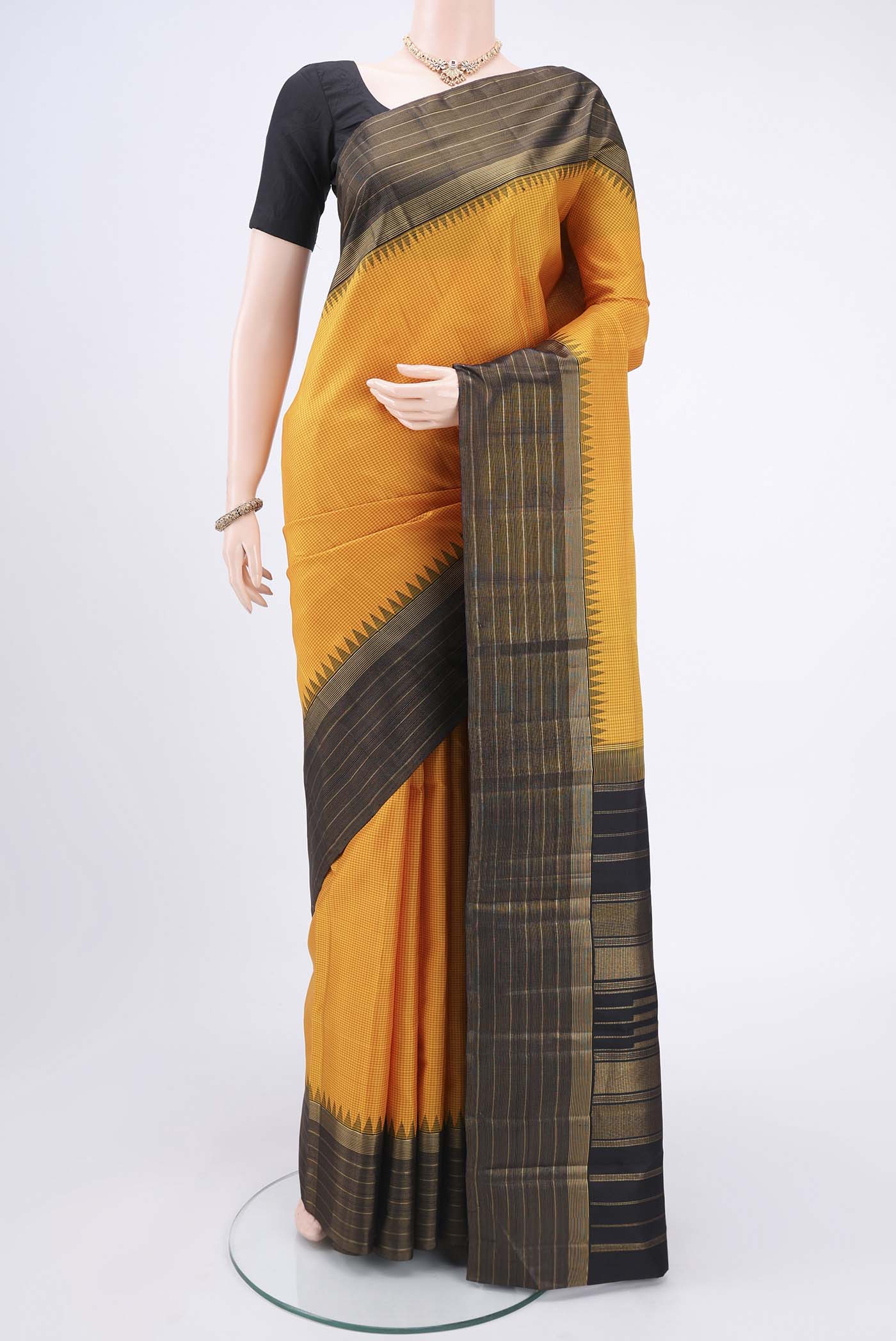 Yellow Kanjivaram Silk Saree with Checked design on the body and Zari Border.  displayed on a mannequin