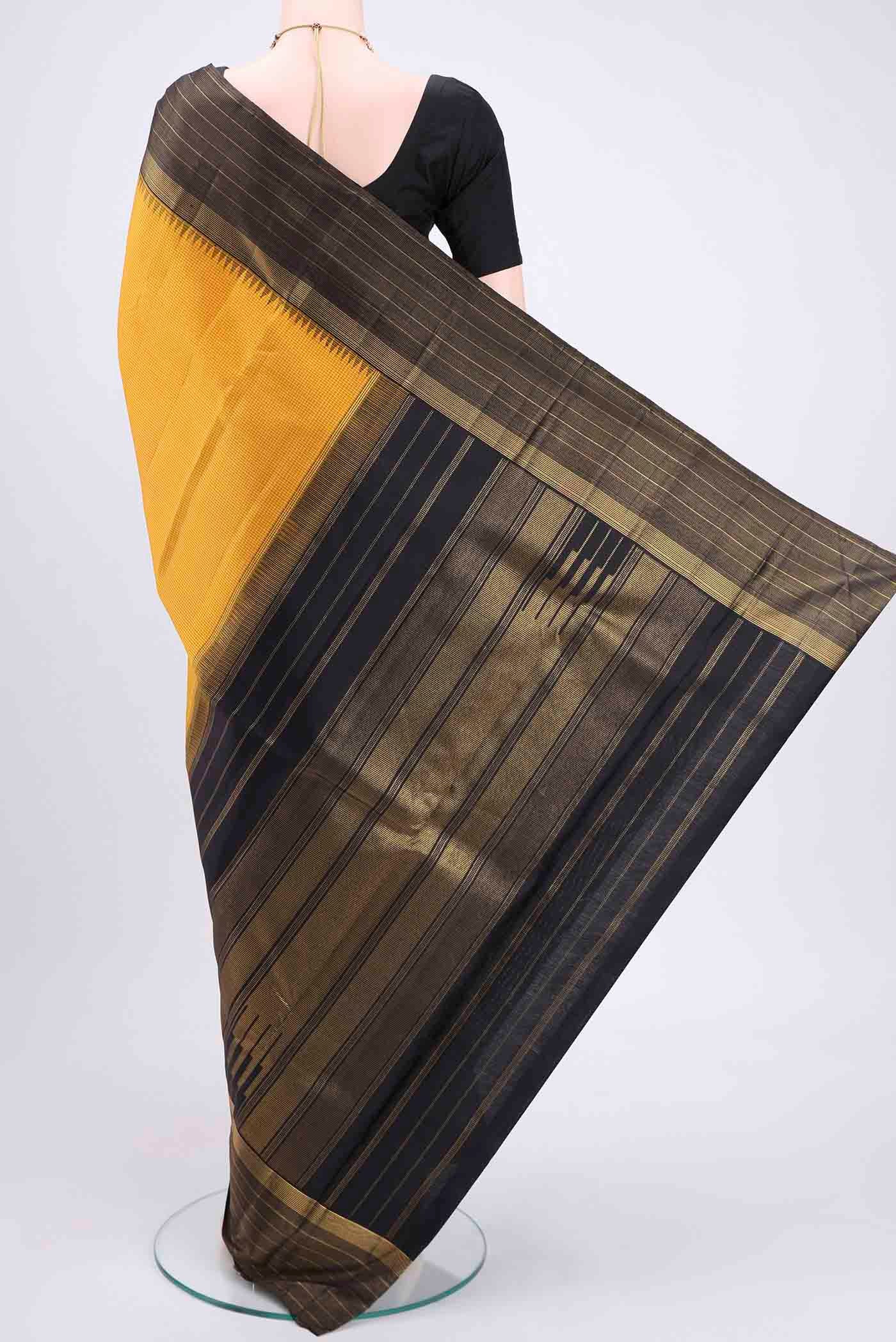 Flat view of Yellow Kanjivaram Silk Saree with Checked design on the body and Zari Border. 