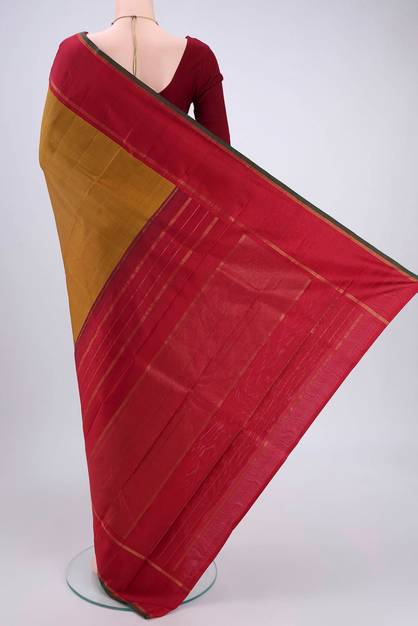 Flat view of Golden Kanchipuram Silk Saree with Plain Body and Zari Border. 