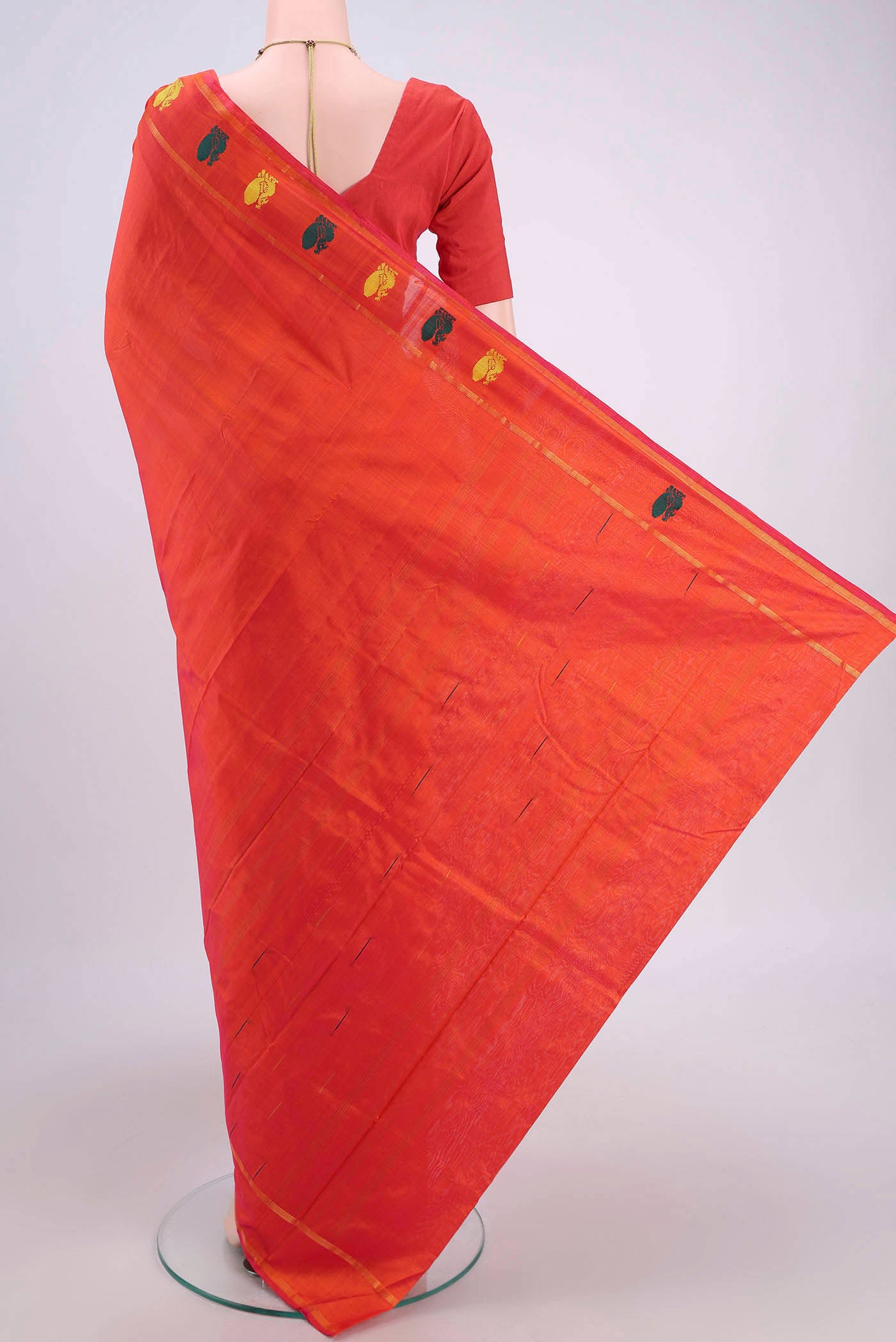 Flat view of Brick Orange Kanchipuram Silk Saree with Plain Body and Zari And Thread Border. 