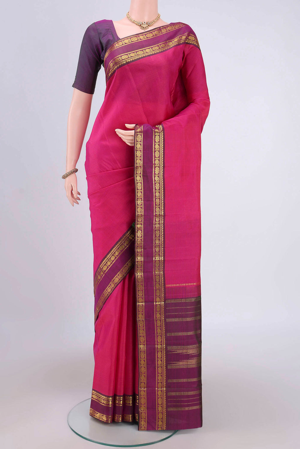 Pink Kanchipuram Silk Saree with Stripes on the body and Zari Border.  displayed on a mannequin