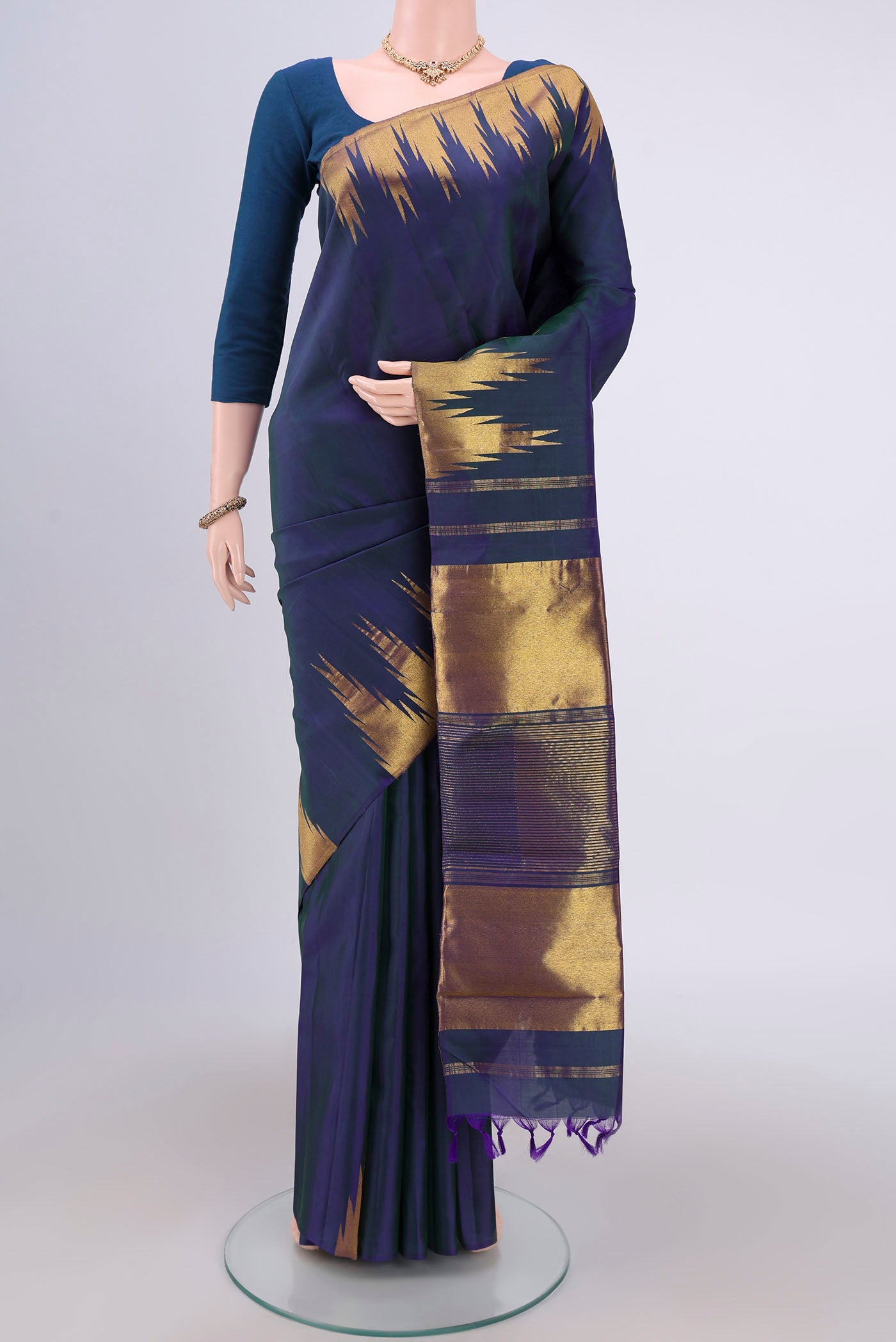 Peacock Blue Kanjivaram Silk Saree with Plain Body and Temple Border.  displayed on a mannequin