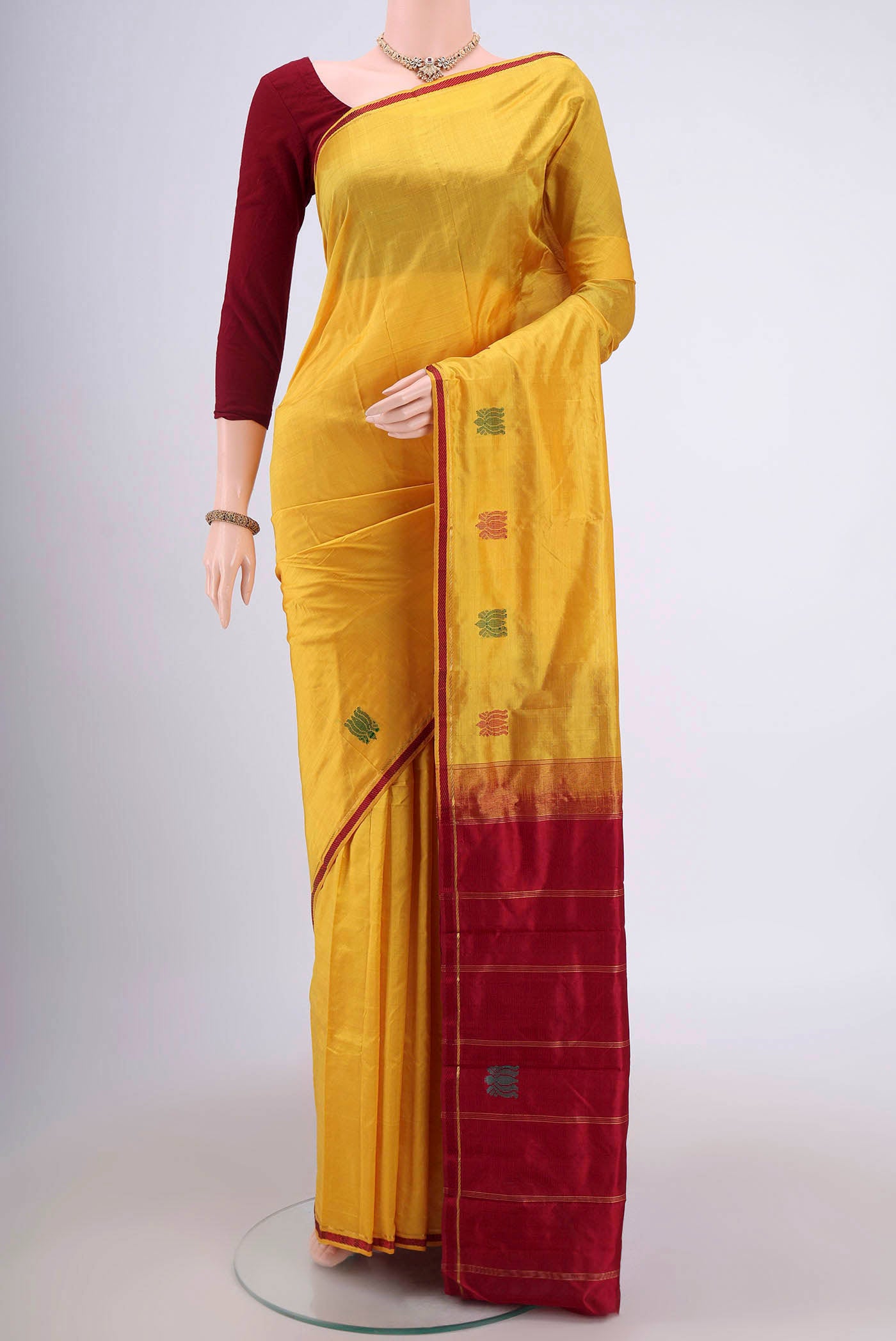 Yellow Kanchipuram Saree with Plain Body and Plain Border.  displayed on a mannequin