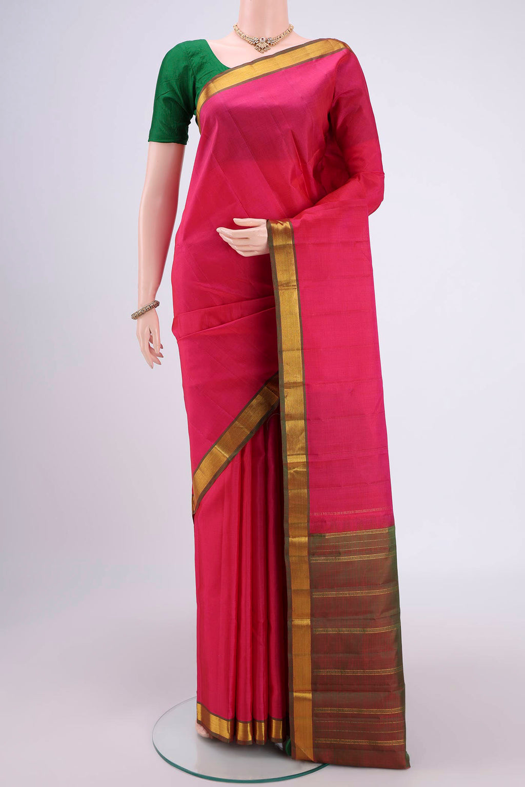 Pink Kanjivaram Silk Saree with Plain Body and Zari Border.  displayed on a mannequin