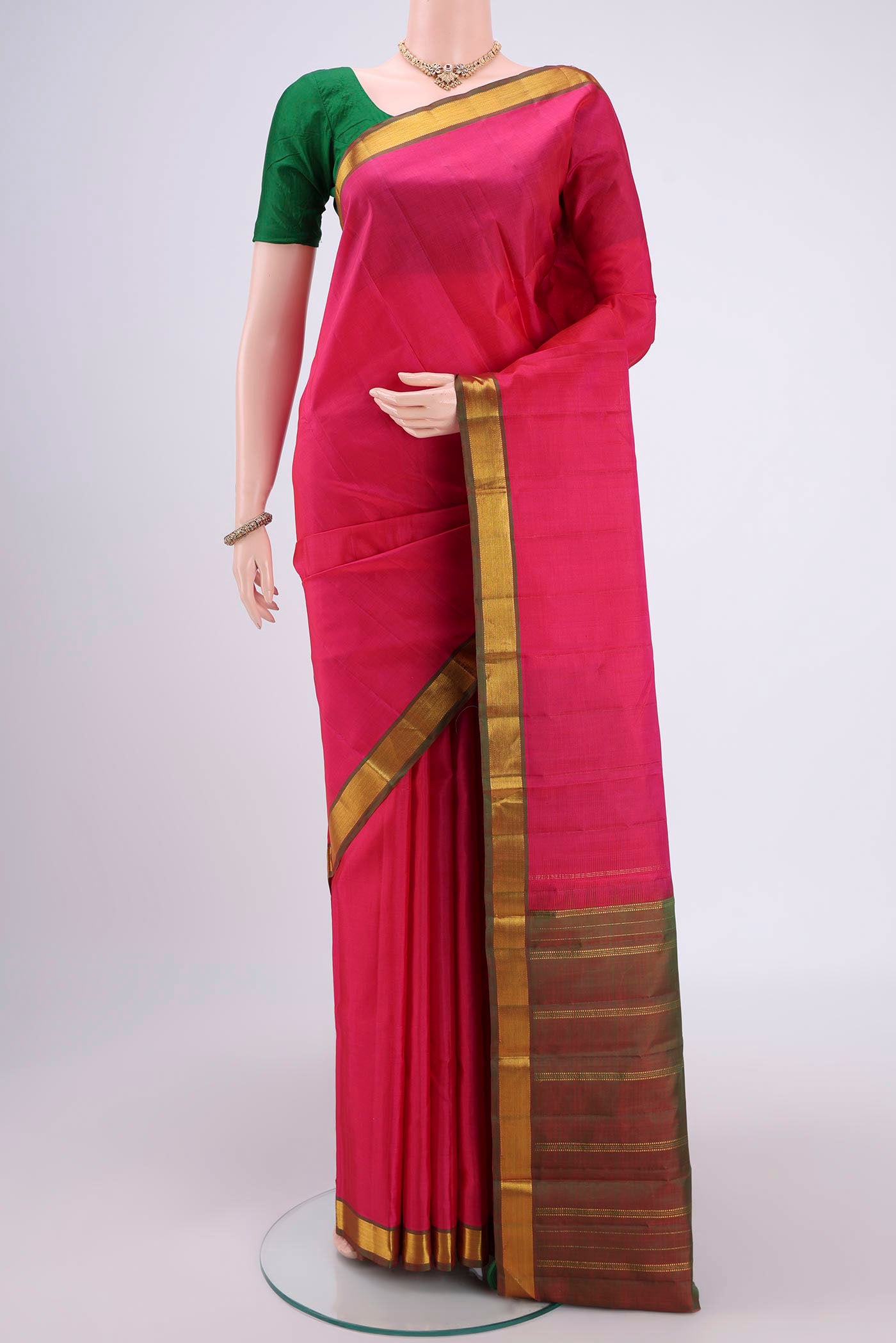 Pink Kanjivaram Silk Saree with Plain Body and Zari Border.  displayed on a mannequin