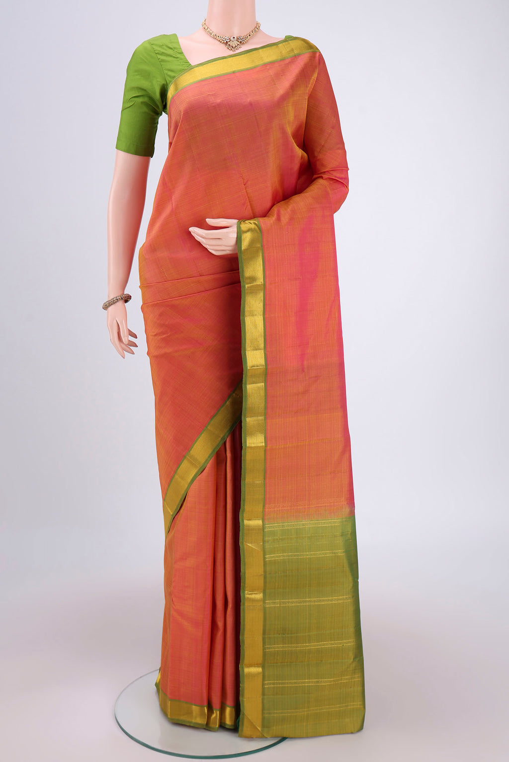 Brick Orange Dual Tone Kanjivaram Silk Saree with Plain Body and Zari Border.  displayed on a mannequin