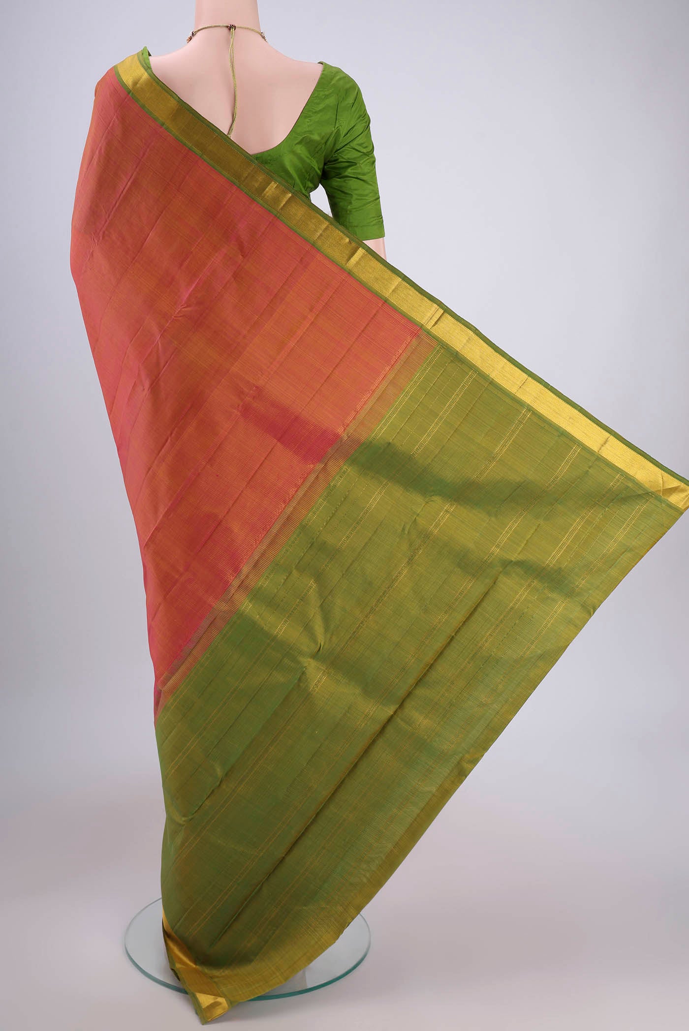 Flat view of Brick Orange Dual Tone Kanjivaram Silk Saree with Plain Body and Zari Border. 