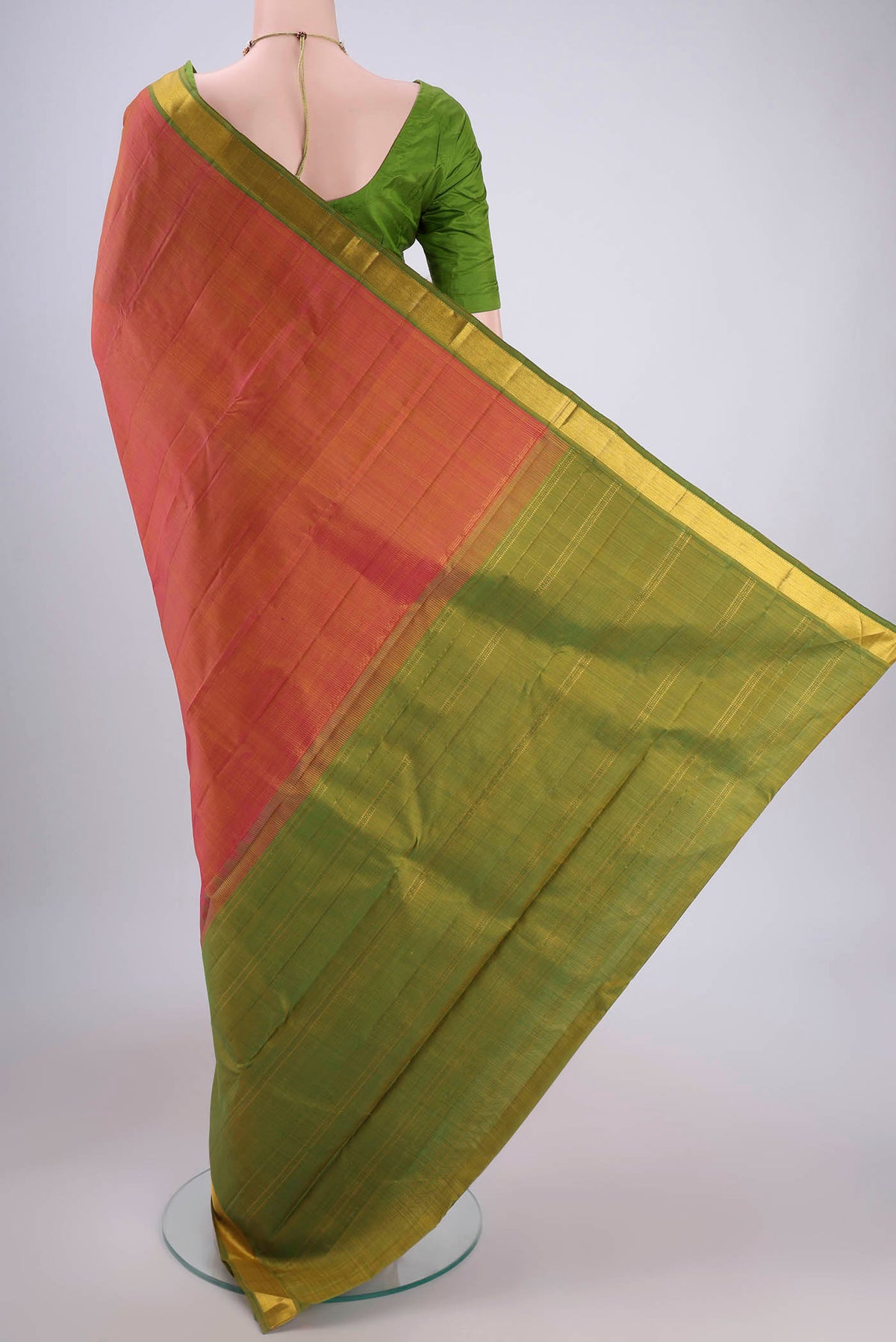 Flat view of Brick Orange Dual Tone Kanjivaram Silk Saree with Plain Body and Zari Border. 