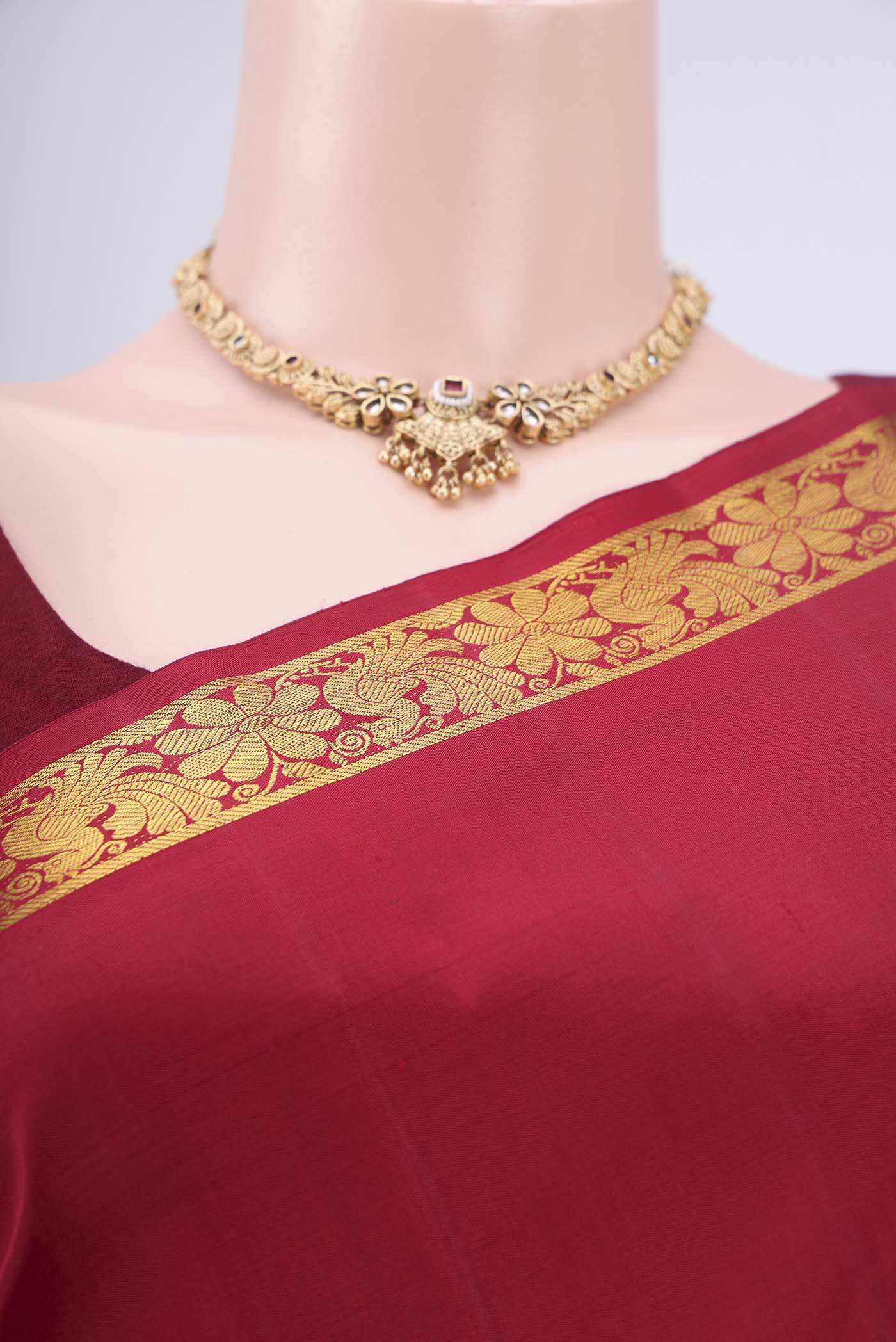 Border image of Maroon Dual Tone Kanjivaram Silk Saree with Plain Body and Zari And Thread Border. 