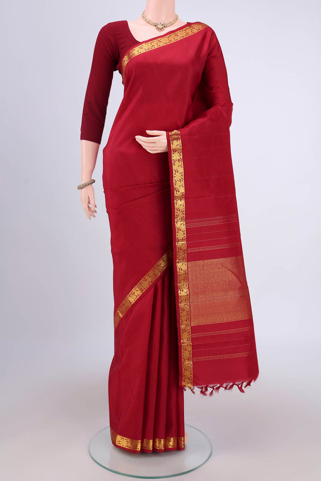 Maroon Dual Tone Kanjivaram Silk Saree with Plain Body and Zari And Thread Border.  displayed on a mannequin