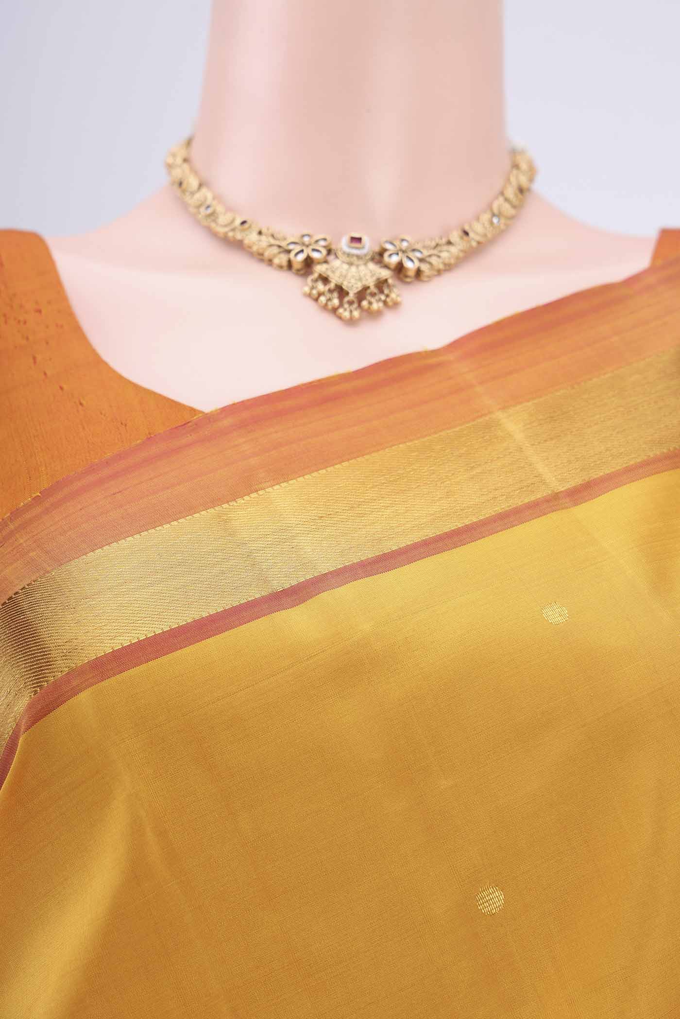 Border image of Mustard Dual Tone Kanjivaram Silk Saree with Zari Butta on the body and Zari Border. 