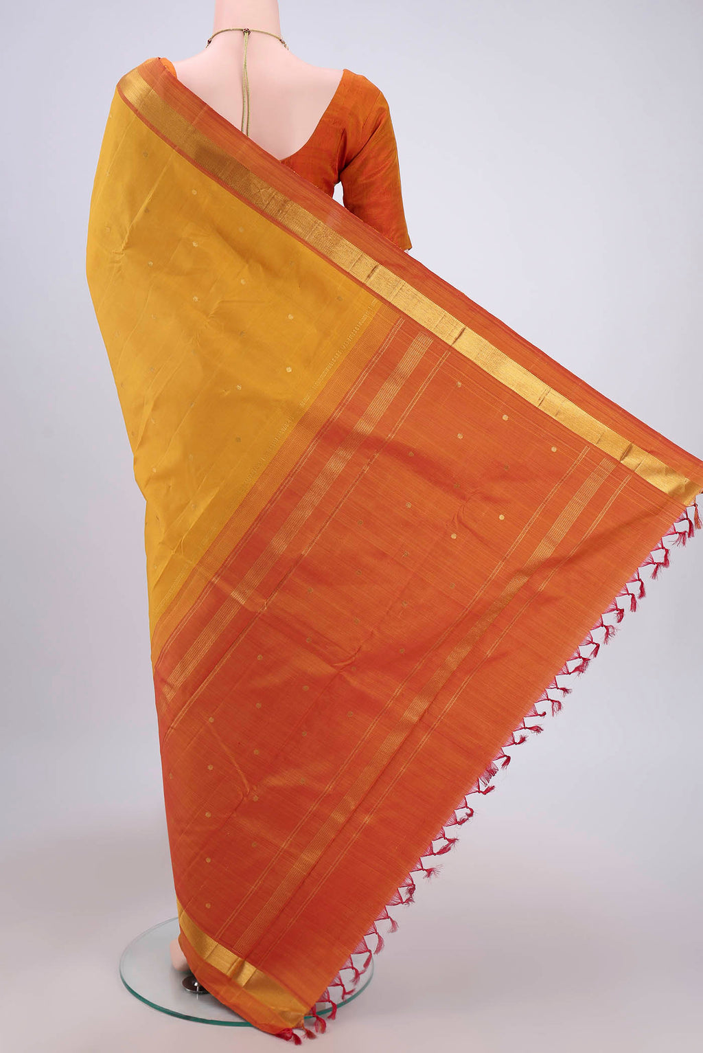 Flat view of Mustard Dual Tone Kanjivaram Silk Saree with Zari Butta on the body and Zari Border. 
