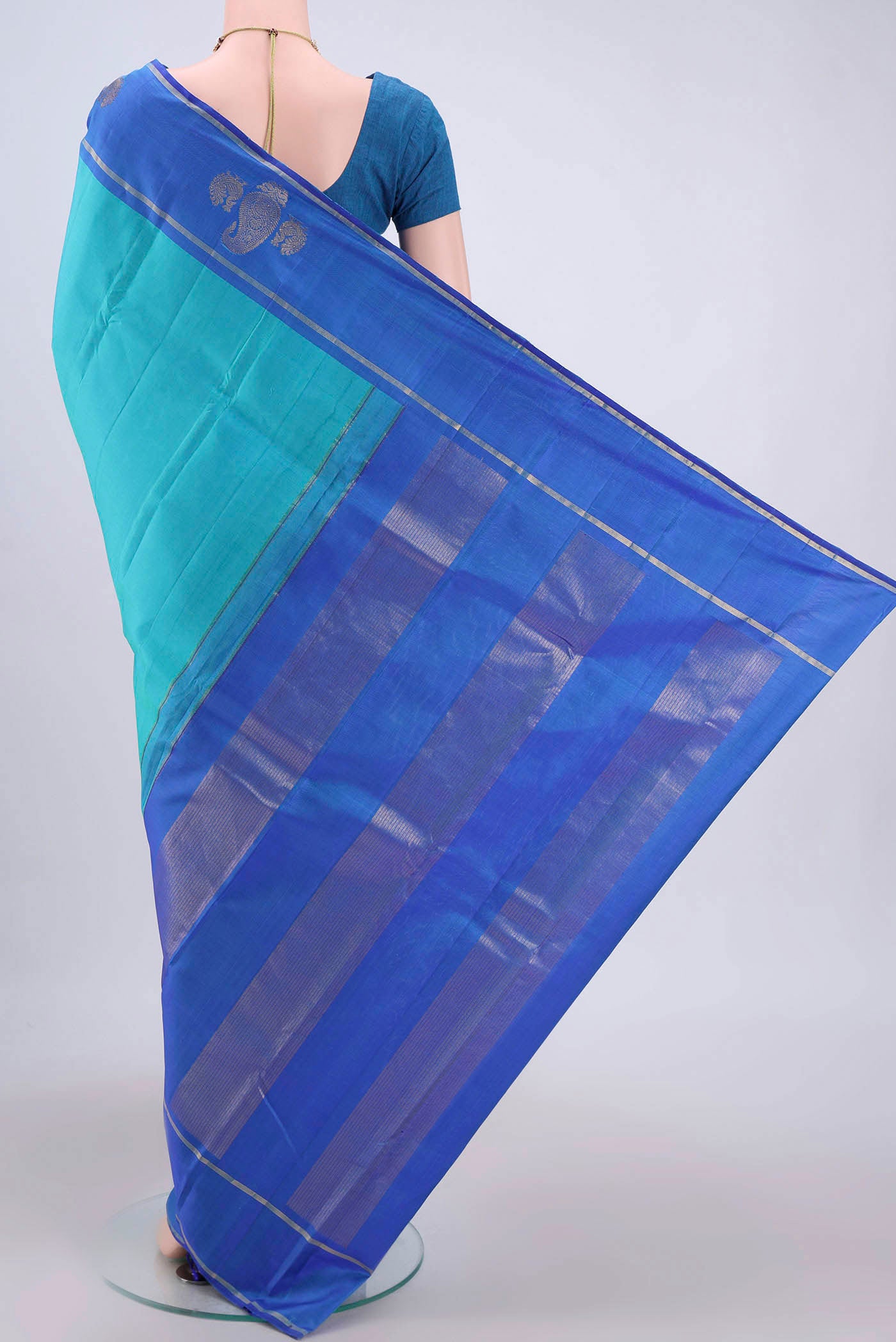 Flat view of Turquoise Kanchipuram Silk Saree with Plain Body and Zari Border. 