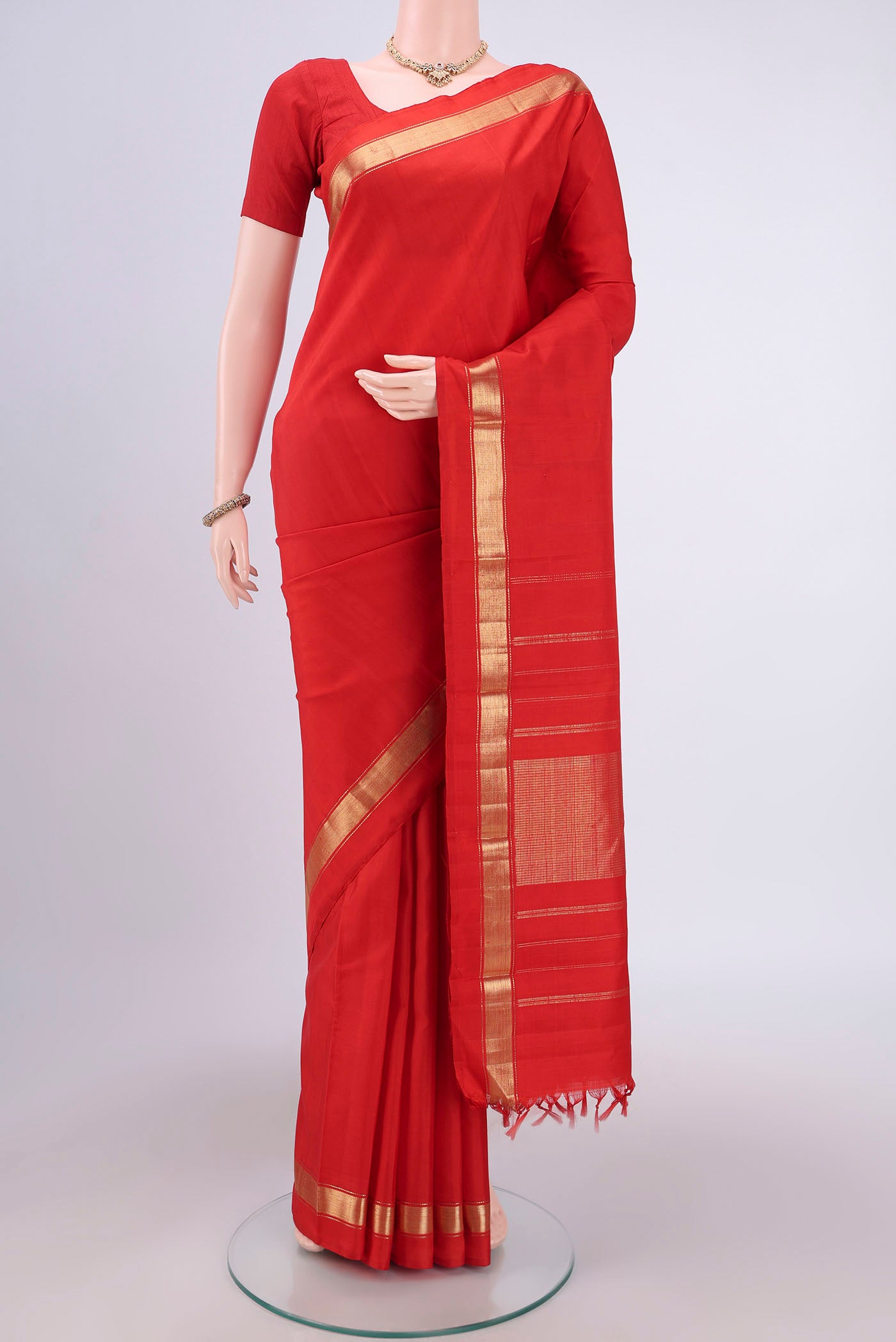 Red Dual Tone Kanjivaram Silk Saree with Plain Body and Zari Border.  displayed on a mannequin