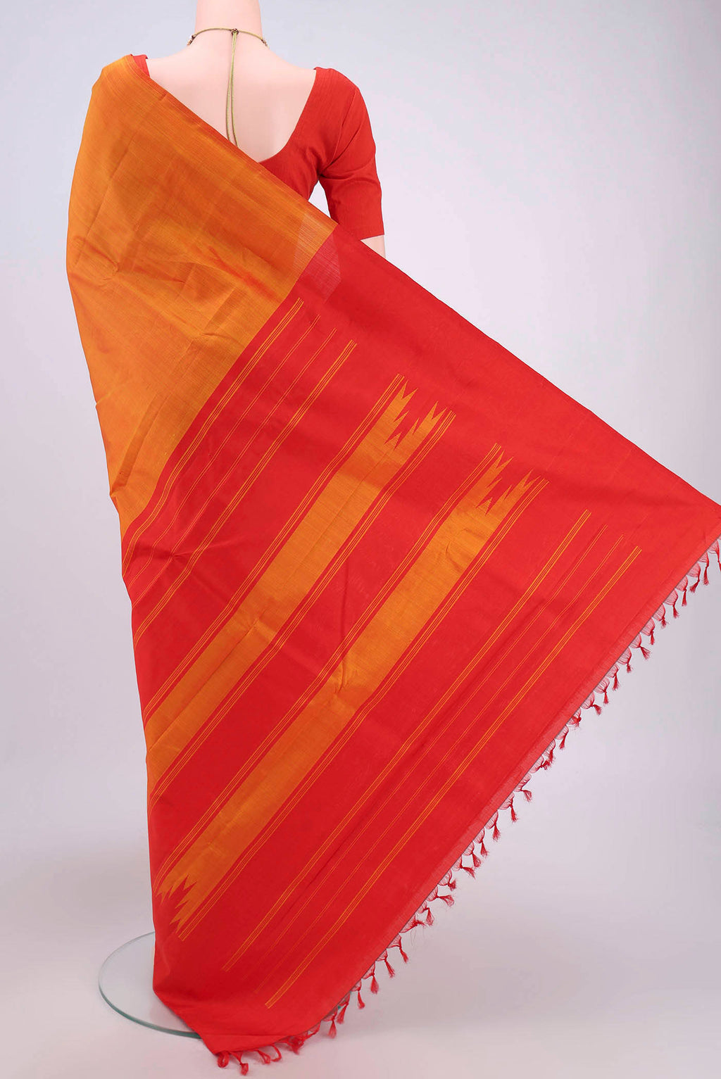 Flat view of Brick Orange Kanchipuram Saree with Plain Body and Rising Temple Border. 