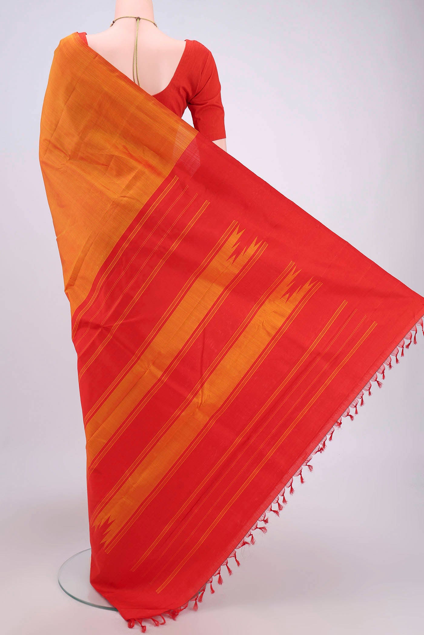 Flat view of Brick Orange Kanchipuram Saree with Plain Body and Rising Temple Border. 