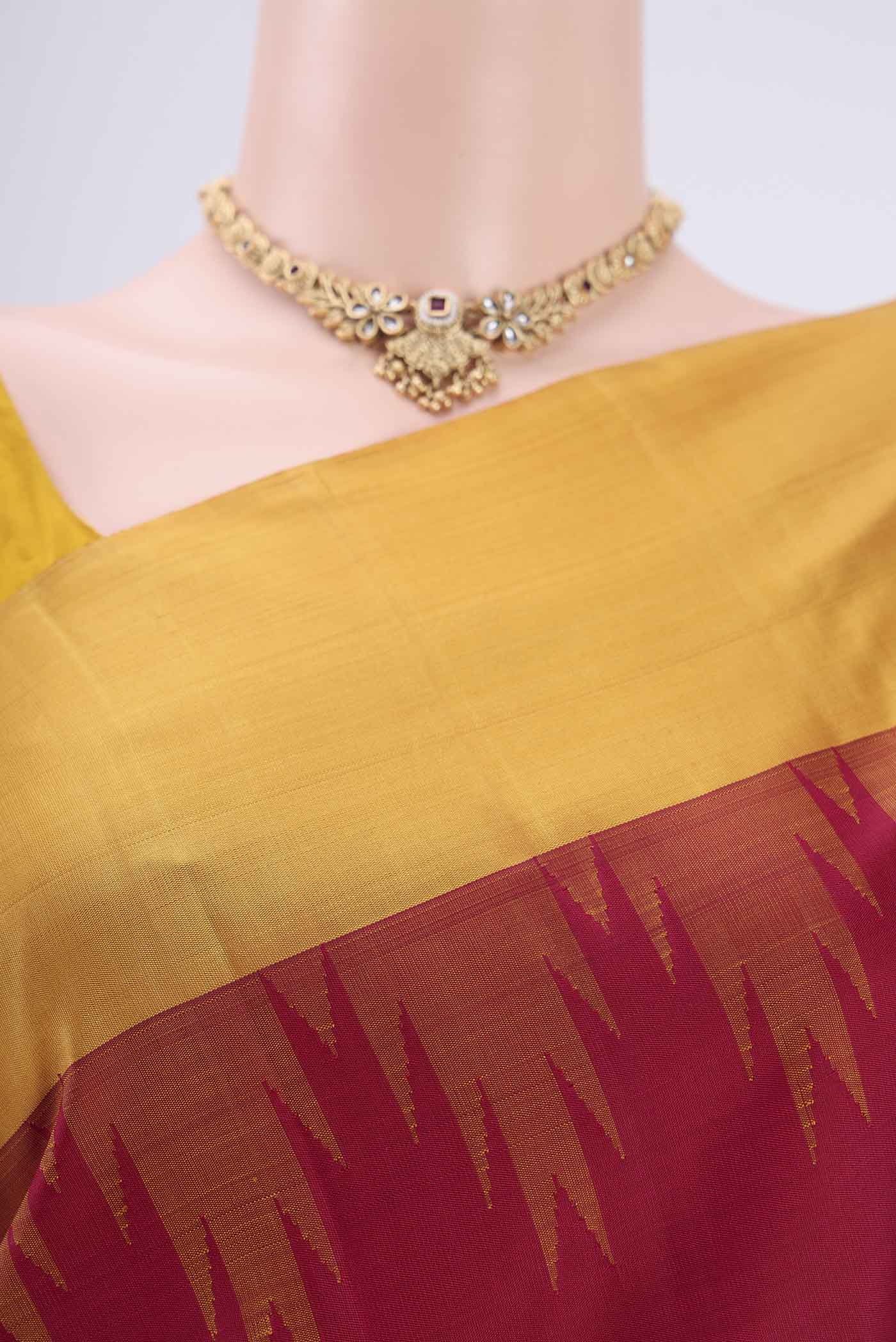 Border image of Maroon Kanjivaram Saree with Plain Body and Zari Border. 
