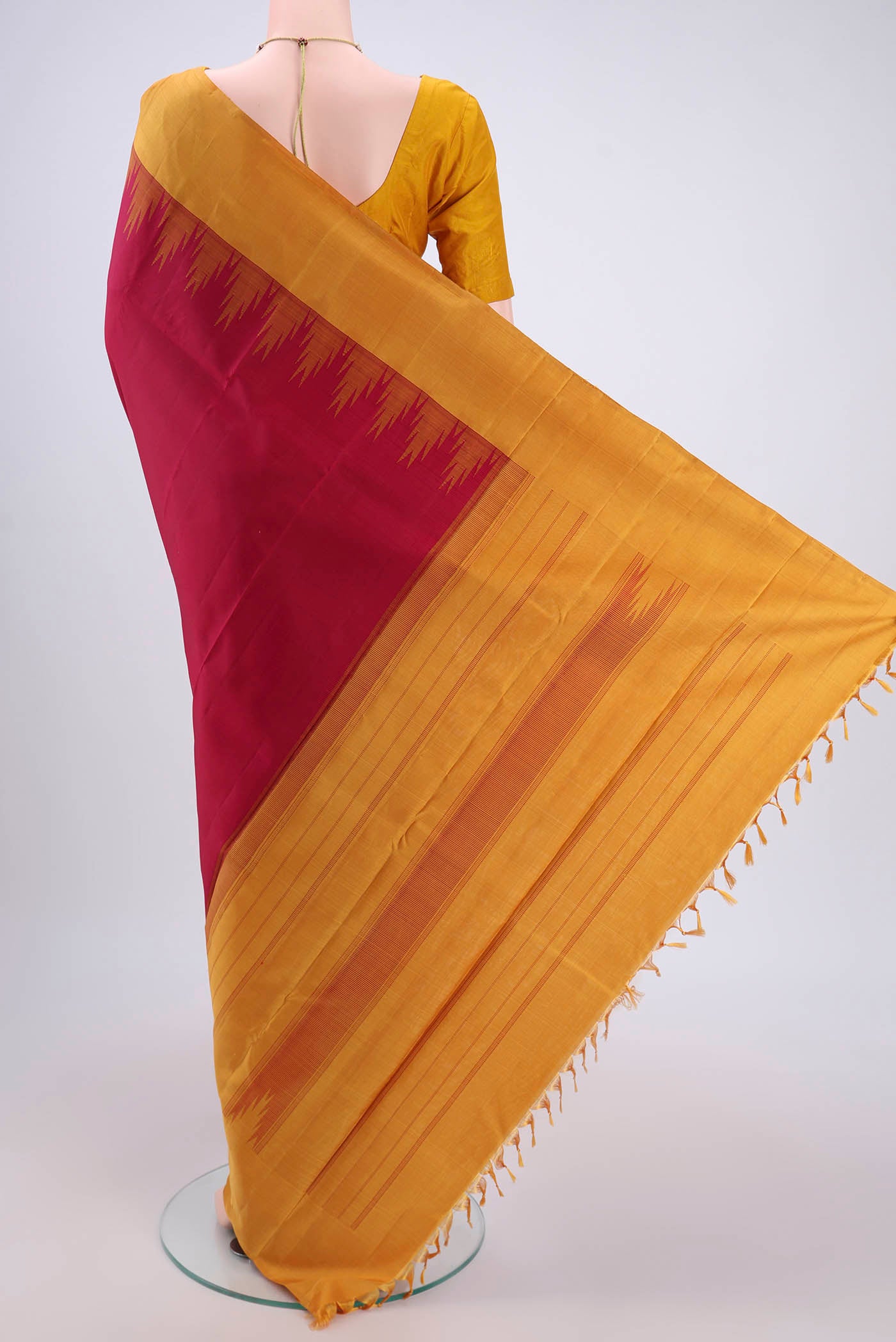 Flat view of Maroon Kanjivaram Saree with Plain Body and Zari Border. 