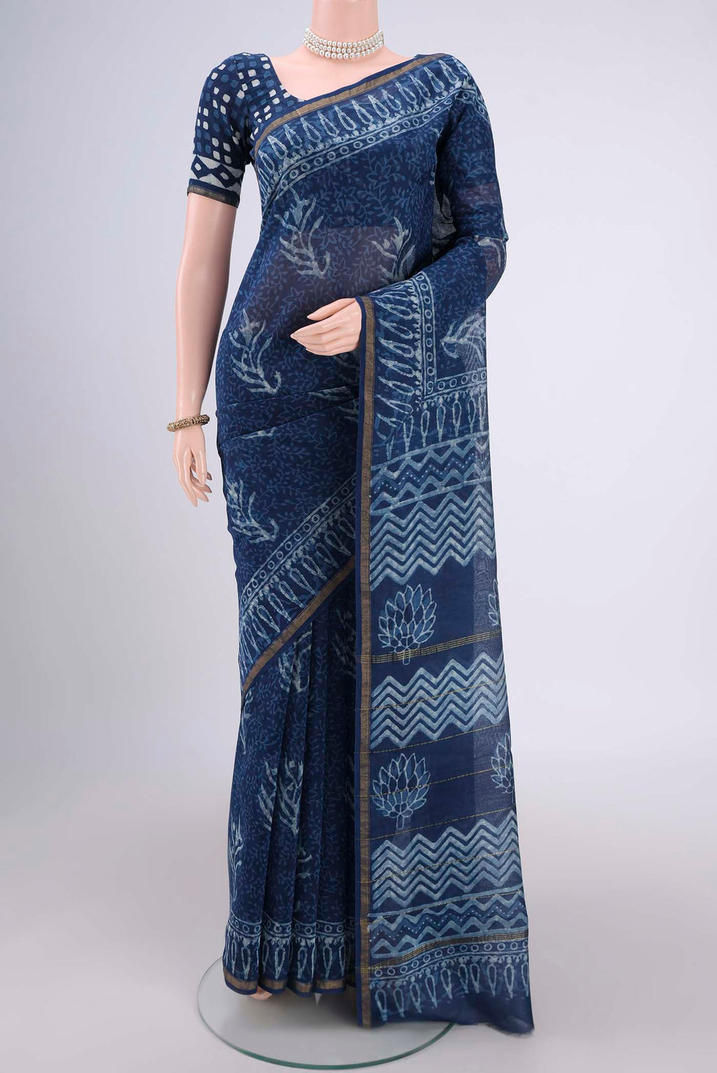 Indigo Maheshwari Silk Cotton Saree with Batik Print on the body and Zari Border.  displayed on a mannequin