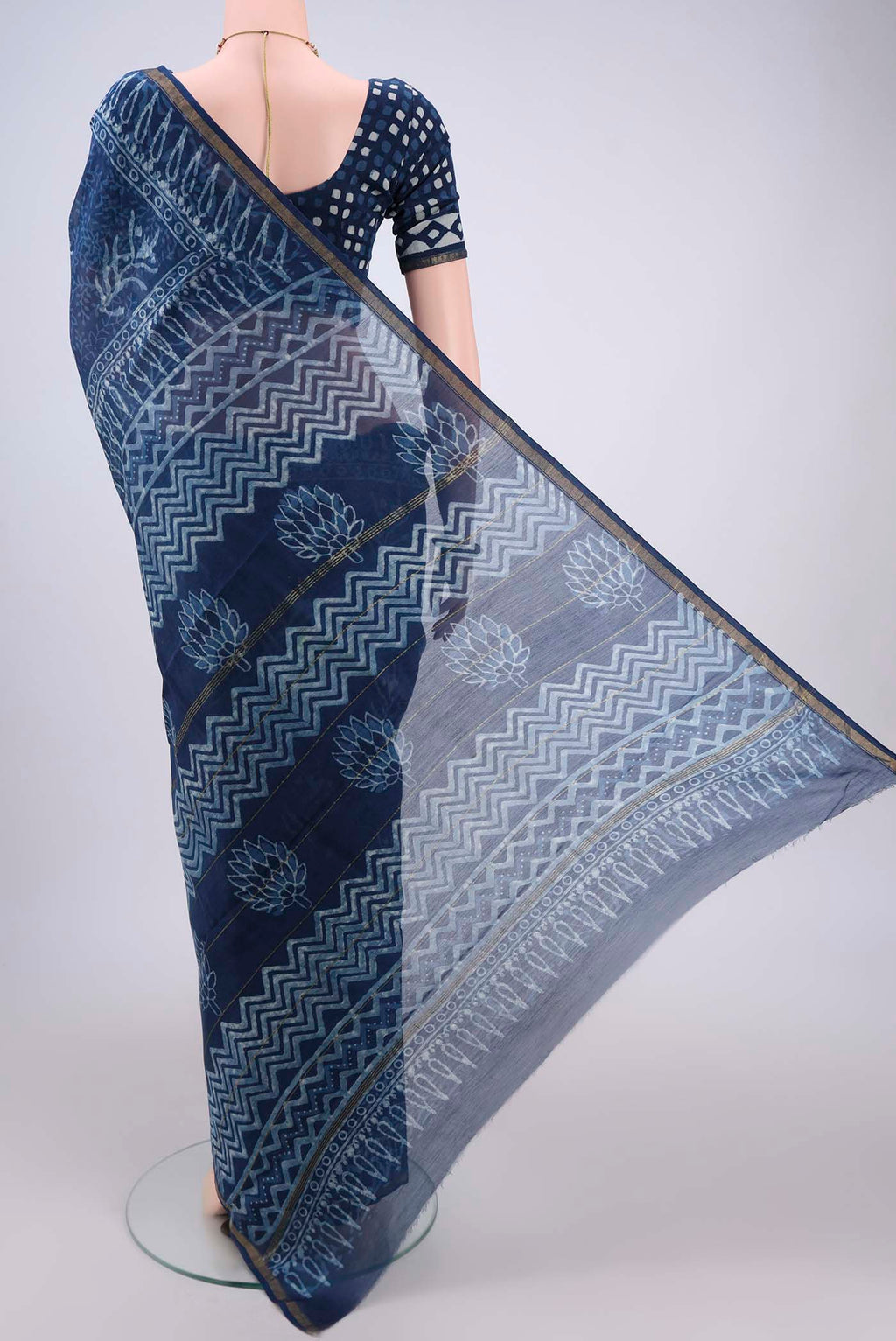 Flat view of Indigo Maheshwari Silk Cotton Saree with Batik Print on the body and Zari Border. 