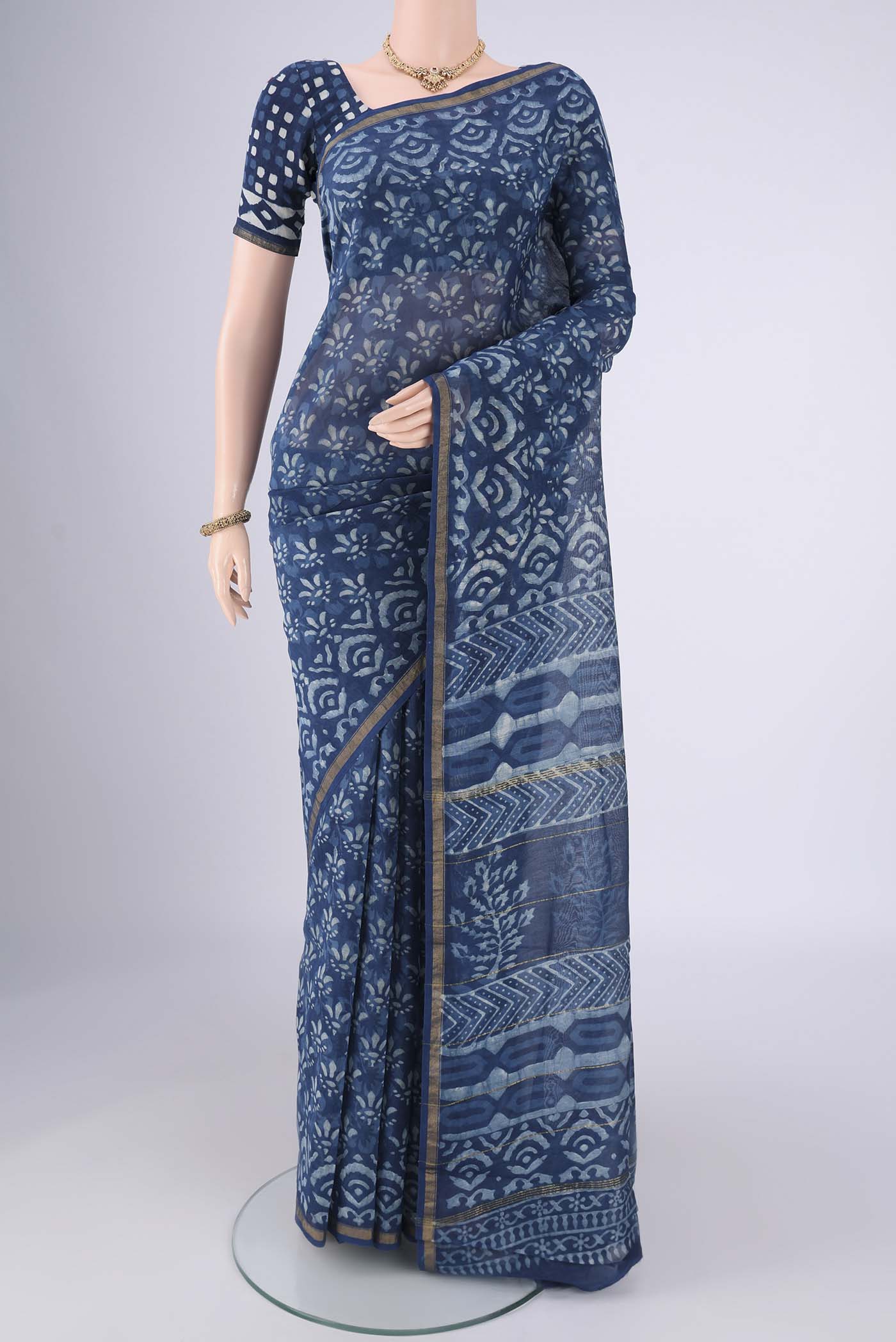 Indigo Maheshwari Silk Cotton Saree with Batik Print on the body and Zari Border.  displayed on a mannequin