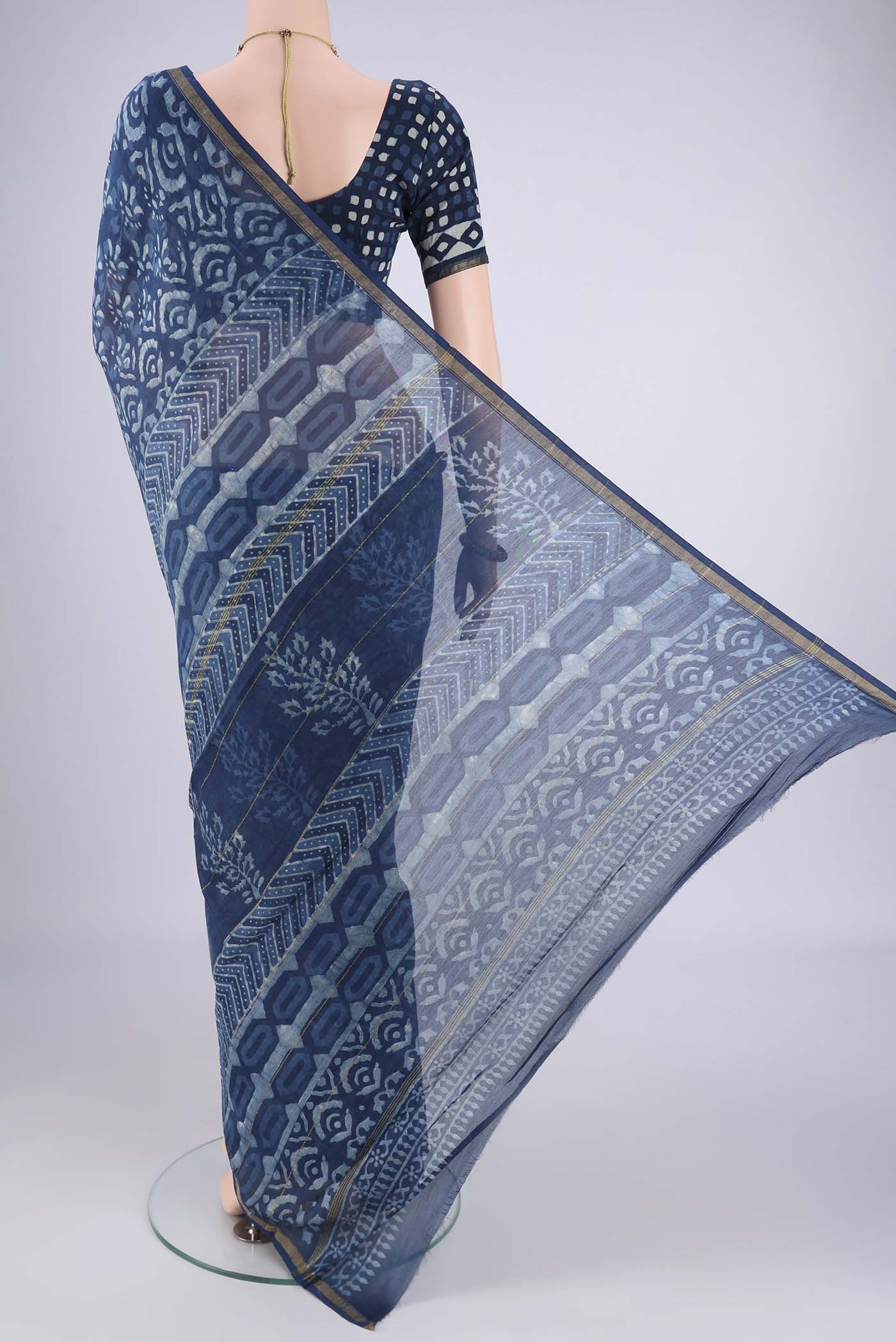 Flat view of Indigo Maheshwari Silk Cotton Saree with Batik Print on the body and Zari Border. 
