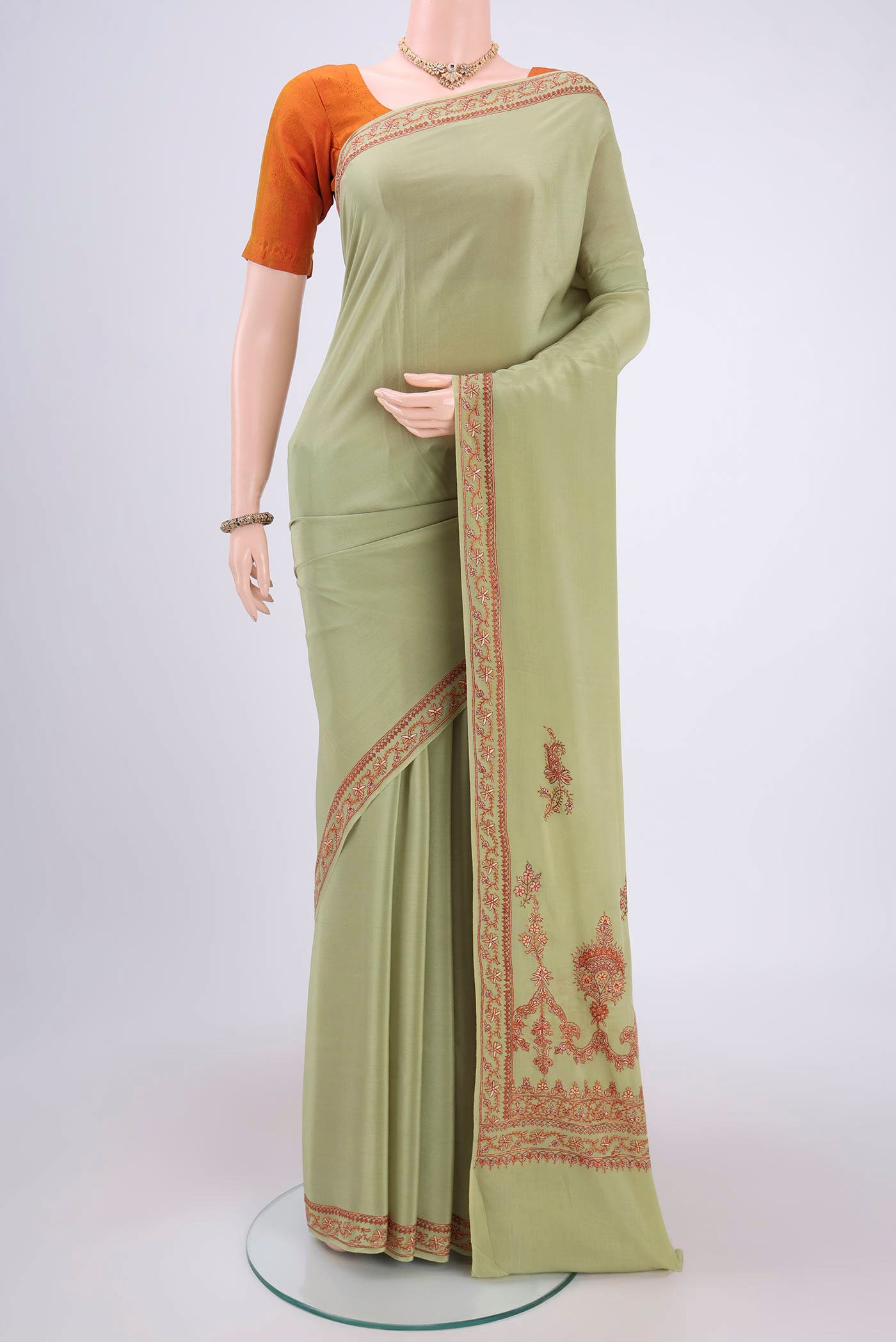 Sage Green Kashmiri Saree with Plain Body and Thread Border.  displayed on a mannequin