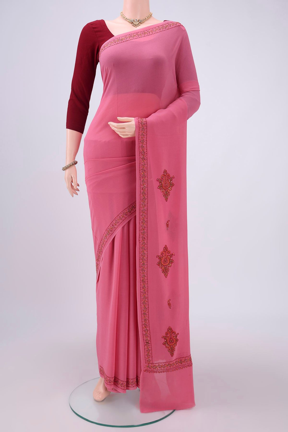 Pink Kashmiri Saree with Plain Body and Thread Border.  displayed on a mannequin