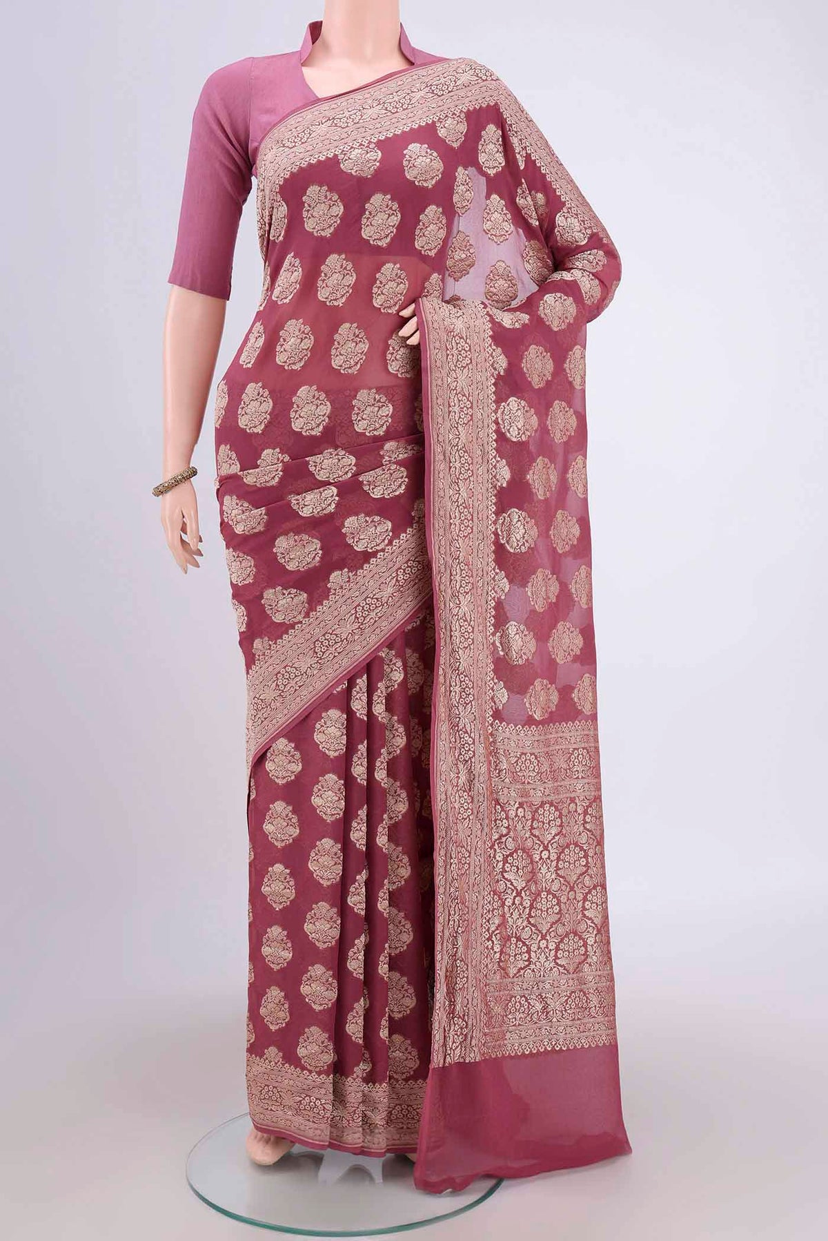 Coral Banarasi Georgette Saree with Zari Brocade on the body and Zari Border.  displayed on a mannequin