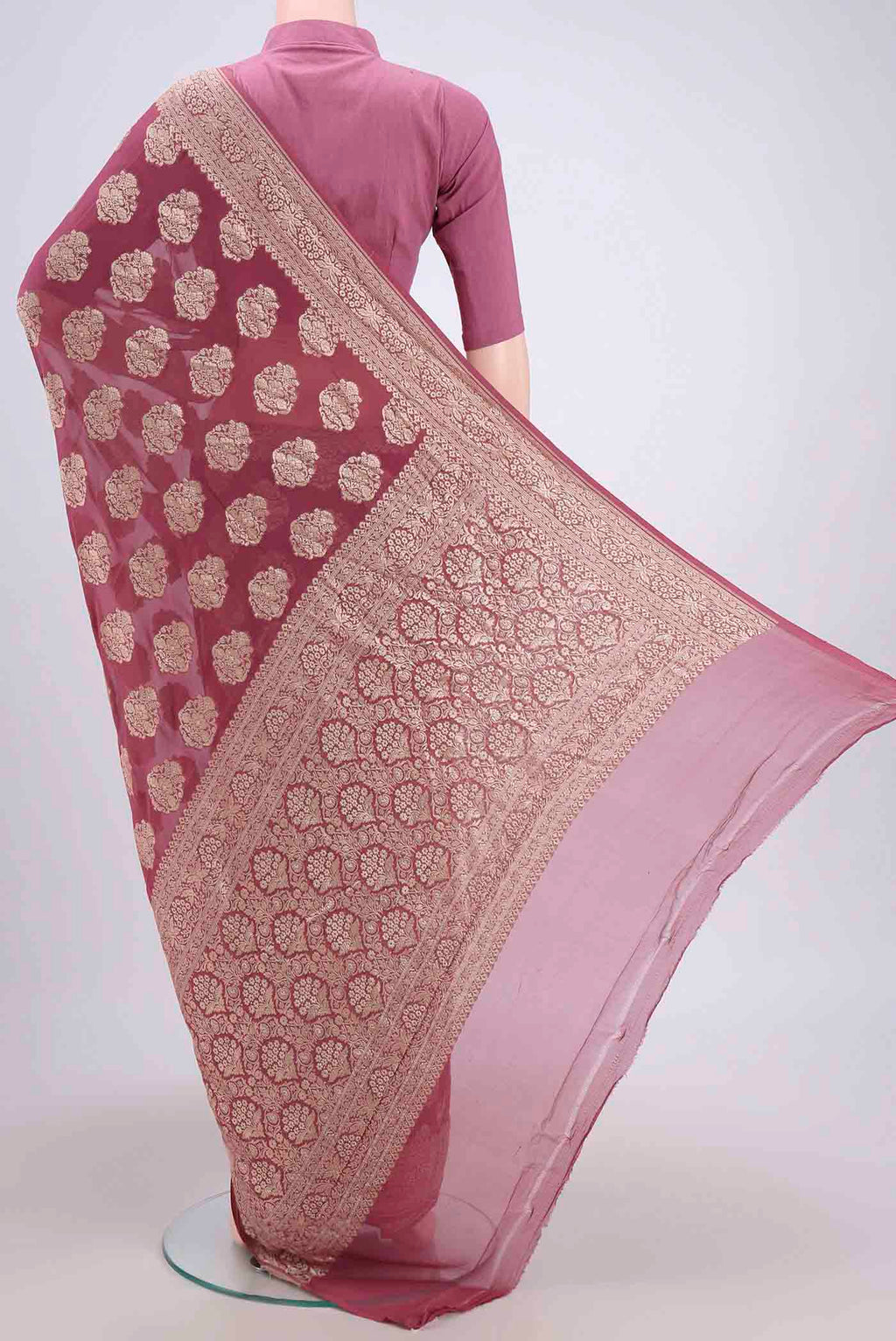 Flat view of Coral Banarasi Georgette Saree with Zari Brocade on the body and Zari Border. 