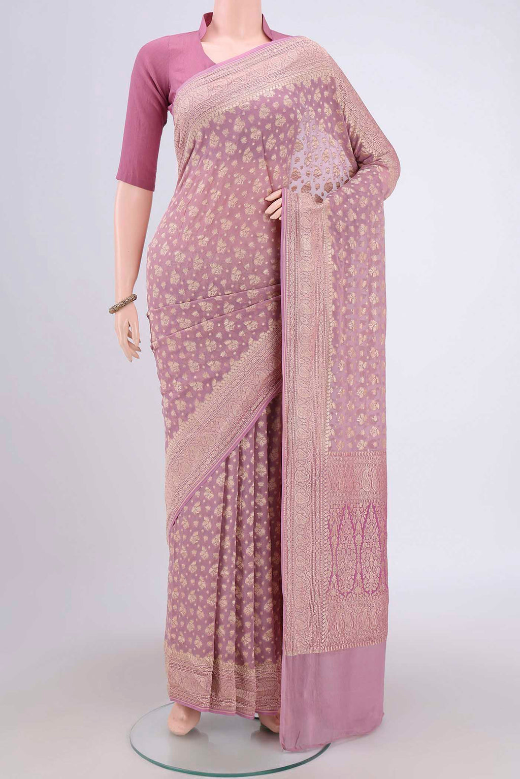 Lilac Banarasi Georgette Saree with Zari Brocade on the body and Zari Border.  displayed on a mannequin