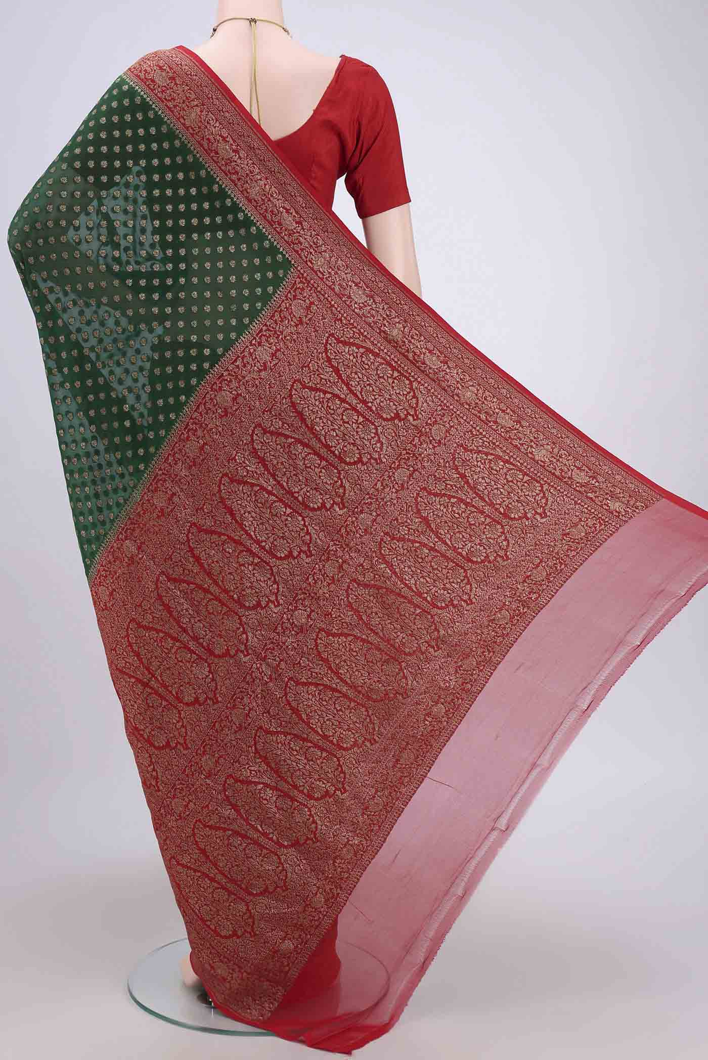 Flat view of Bottle Green Banarasi Georgette Saree with Checked design on the body and Zari Border. 