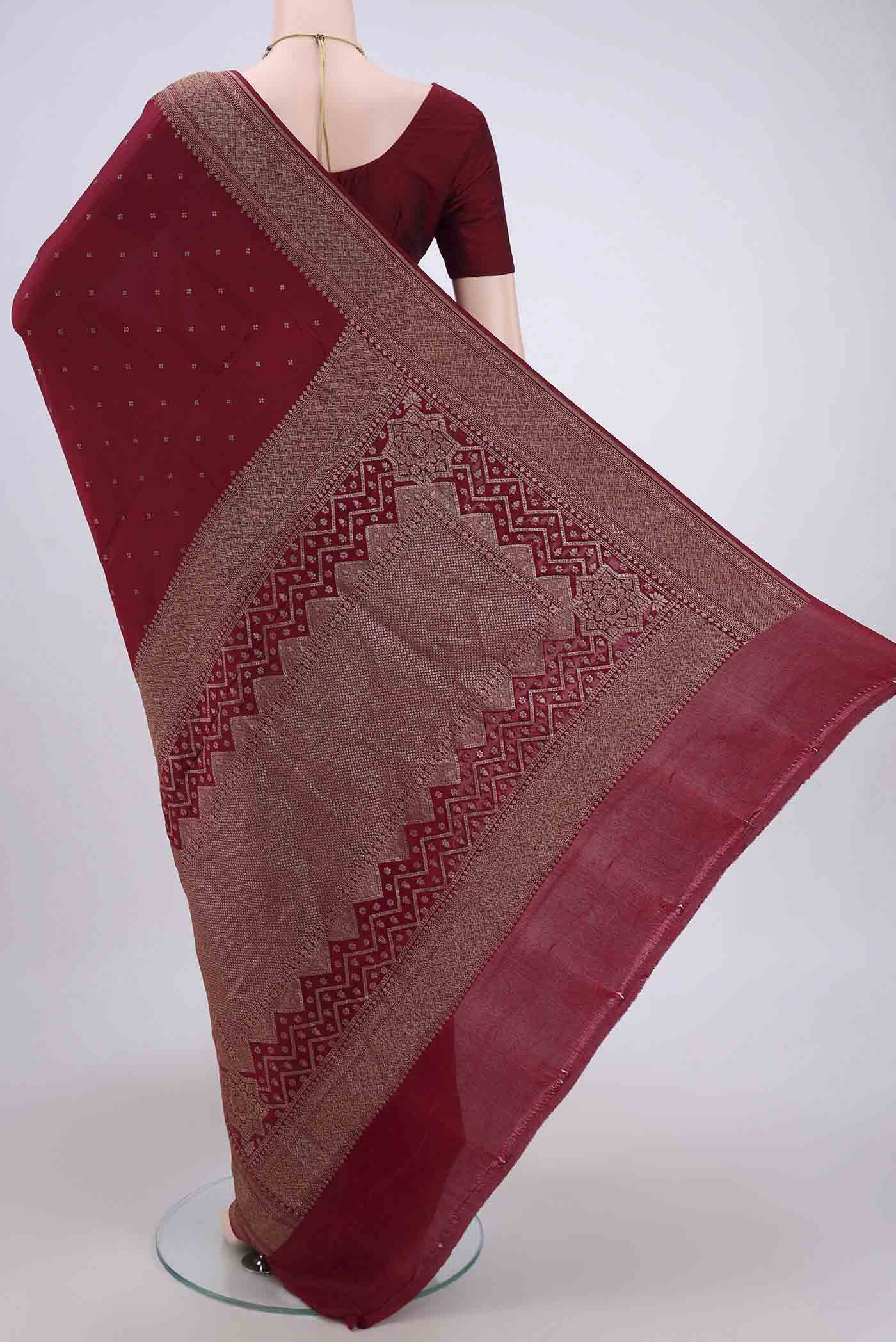 Flat view of Maroon Banarasi Georgette Saree with Zari Butta on the body and Zari Border. 