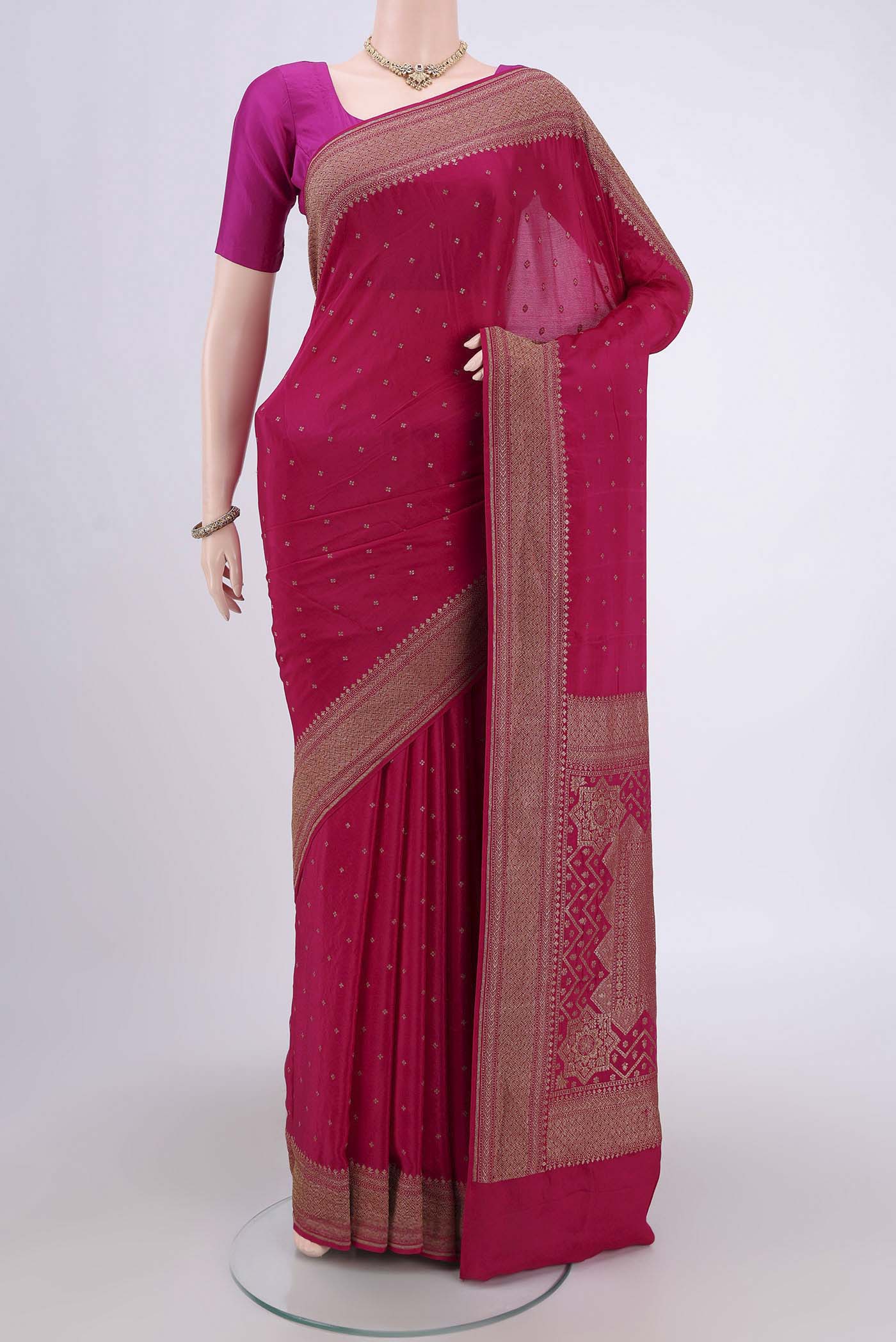 Rani Pink Banarasi Georgette Saree with Zari Butta on the body and Zari Border.  displayed on a mannequin