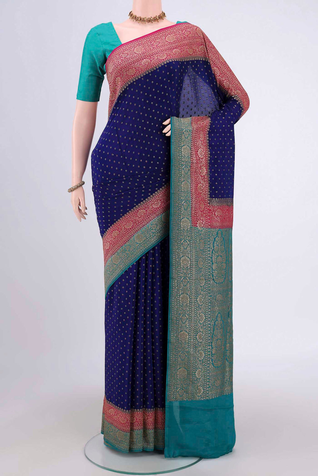 Royal Blue Banarasi Georgette Saree with Zari Butta on the body and Zari Border.  displayed on a mannequin