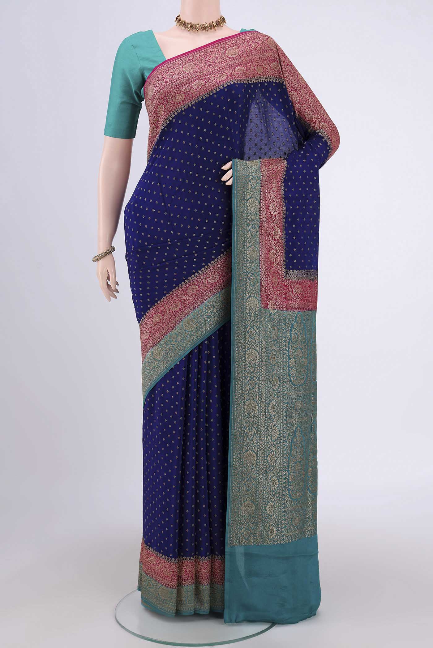 Royal Blue Banarasi Georgette Saree with Zari Butta on the body and Zari Border.  displayed on a mannequin