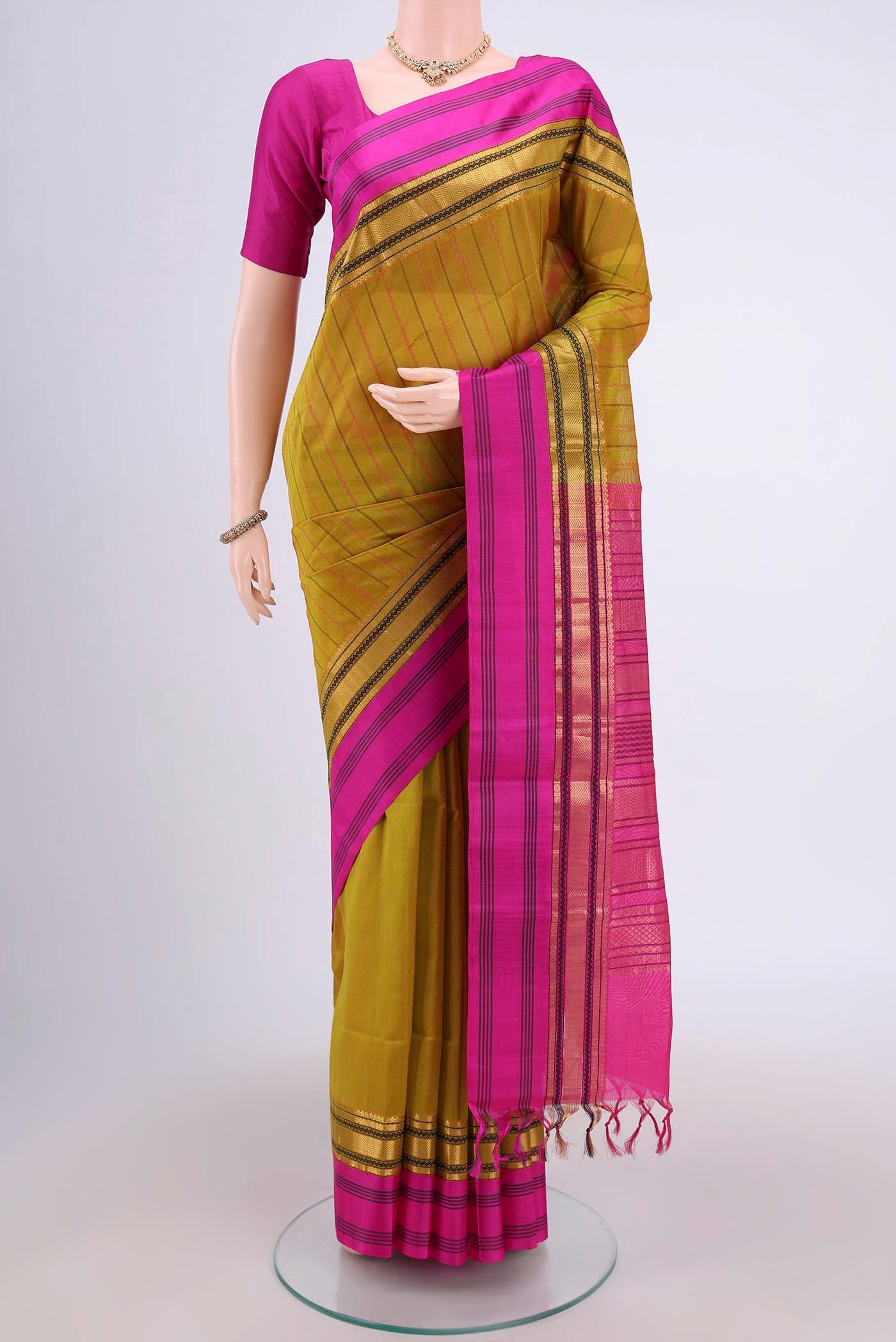Green Coimbatore Silk Cotton Saree with Stripes on the body and Plain Border.  displayed on a mannequin