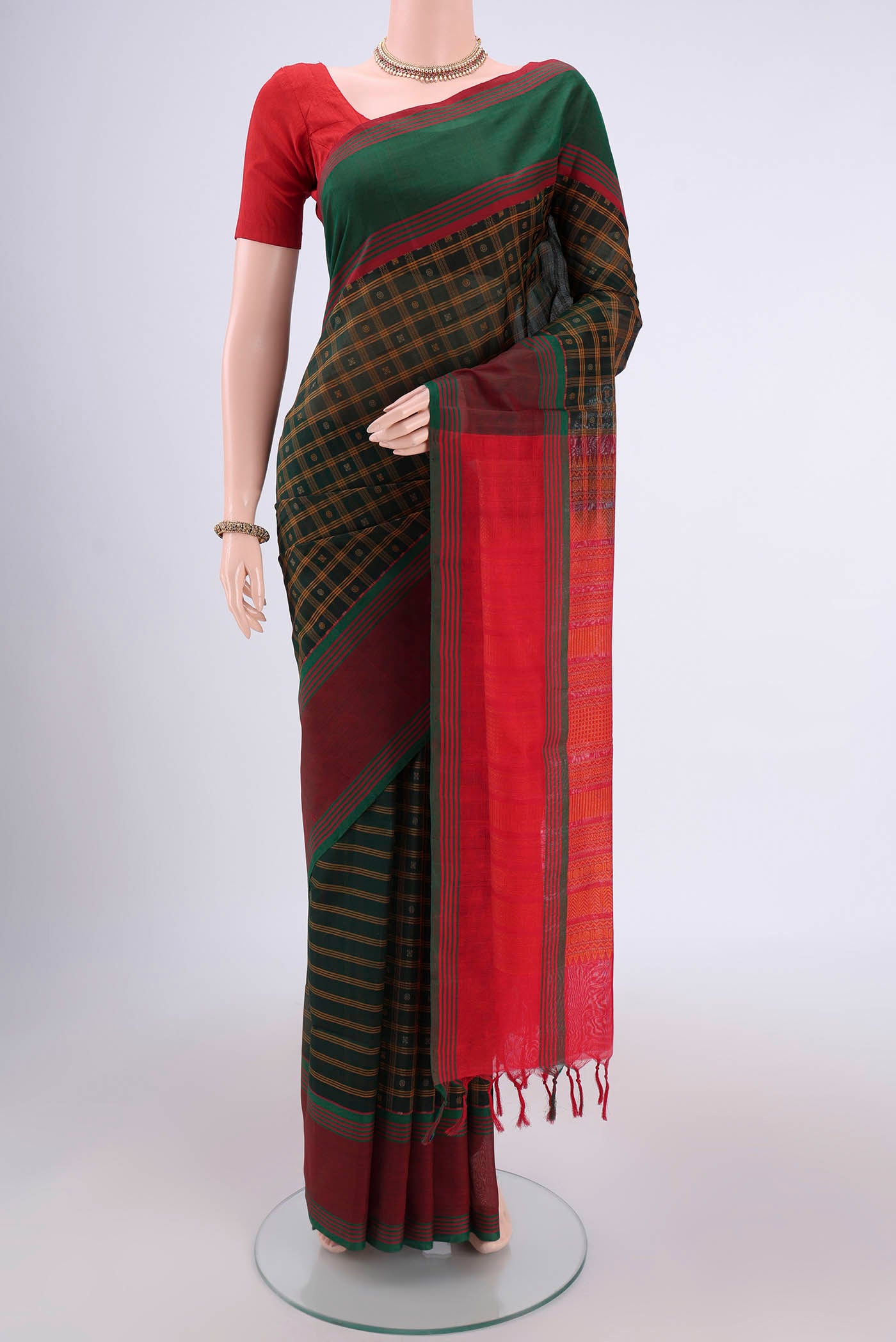 Bottle Green Silk Cotton Saree with Checked design on the body and Plain Border.  displayed on a mannequin