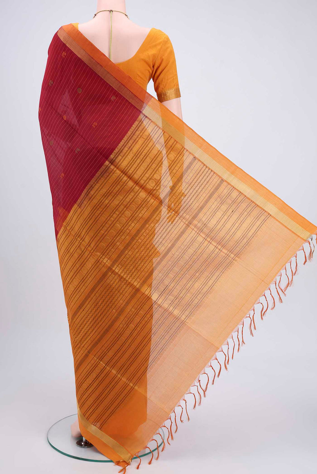 Flat view of Maroon Coimbatore Silk Cotton Saree with Stripes on the body and Zari Border. 