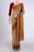 Beige Silk Cotton Saree with Veldhari on the body and Zari And Thread Border.  displayed on a mannequin